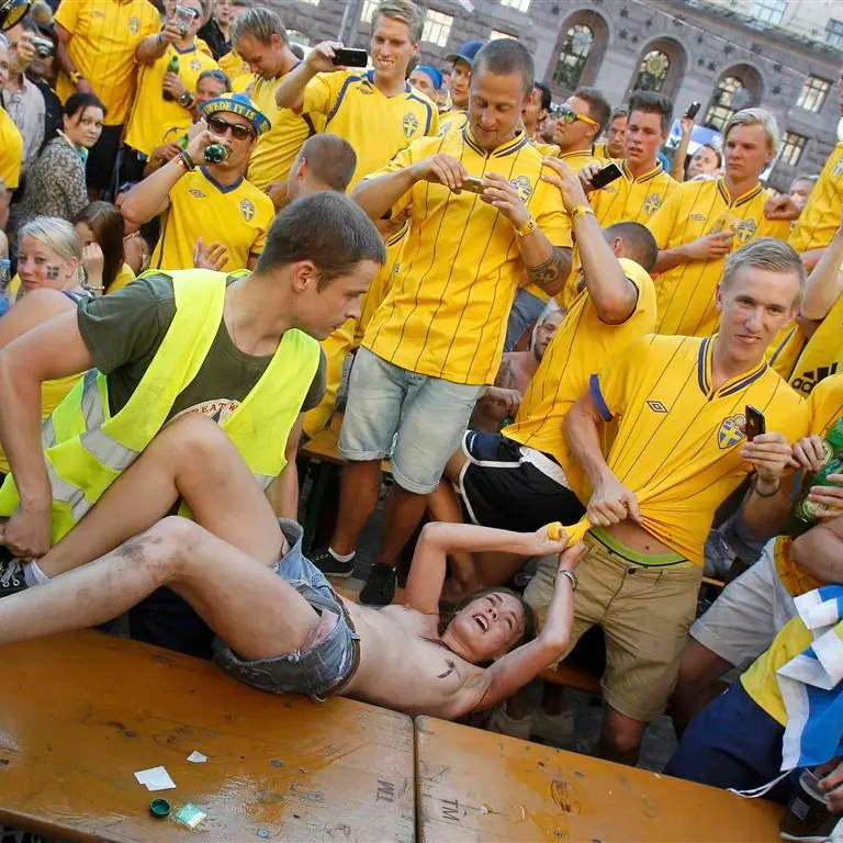 Euro fans mistake topless protest for street striptease