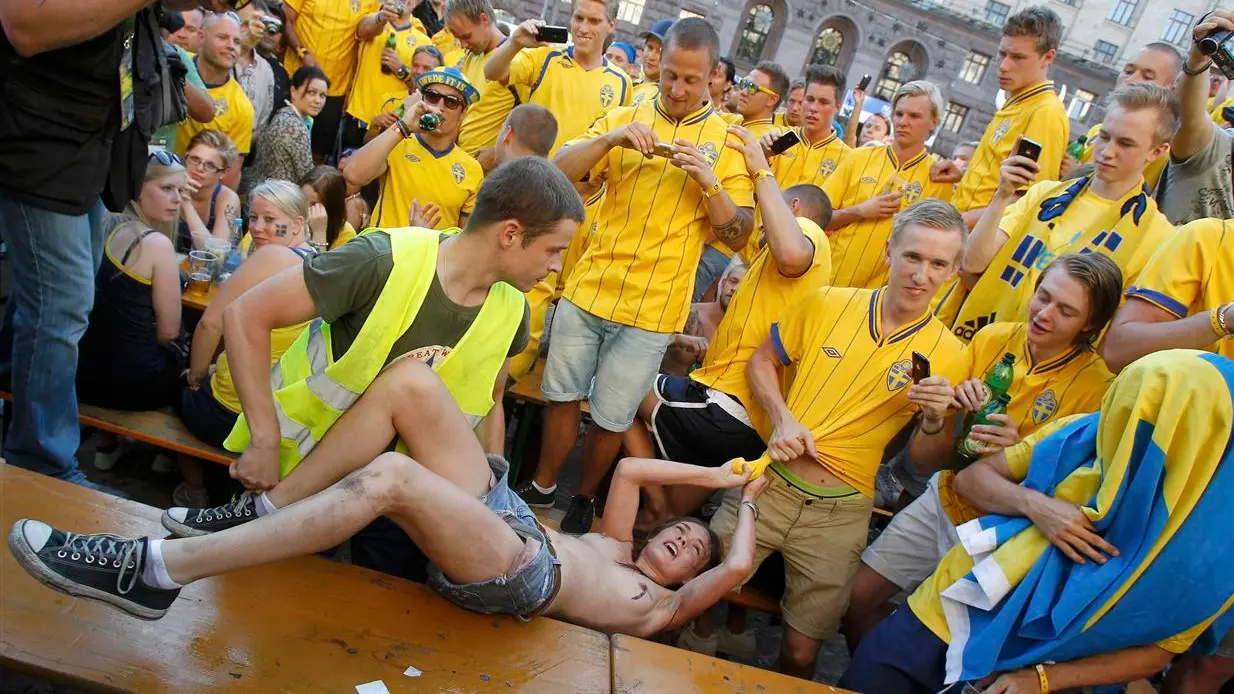 Euro fans mistake topless protest for street striptease