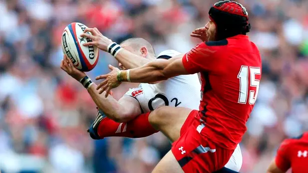Rugby: England down Wales to stay in title hunt