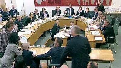 Protester attacks Murdoch during dramatic hearing