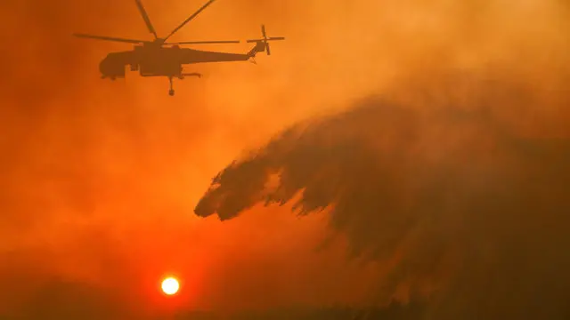 Firefighters battle wildfires across Greece