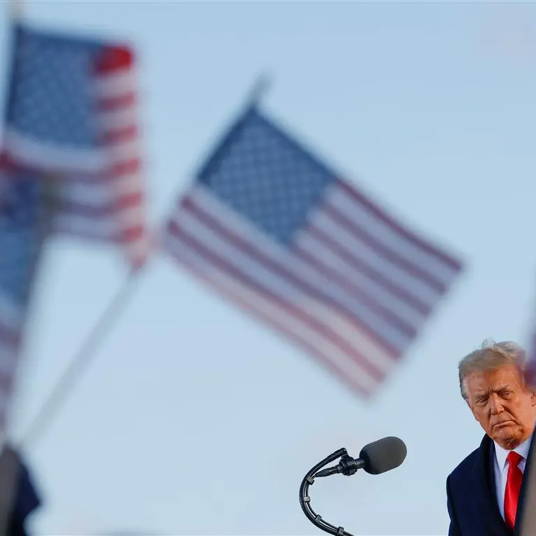 Trump departs White House, hints at return