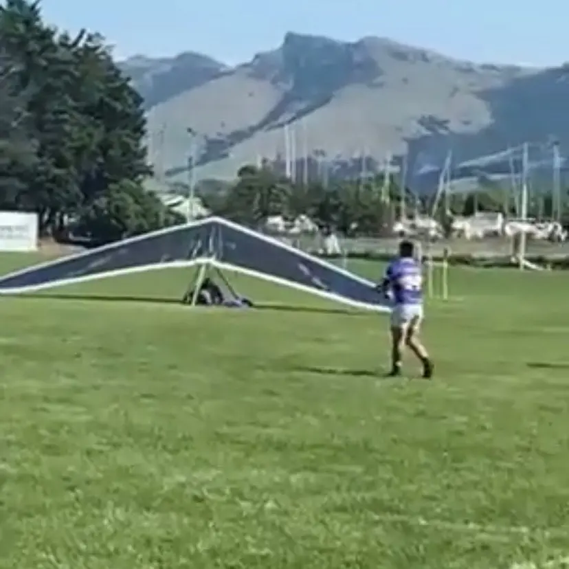 Crashing through the defence: Hang glider comes down in middle of rugby game