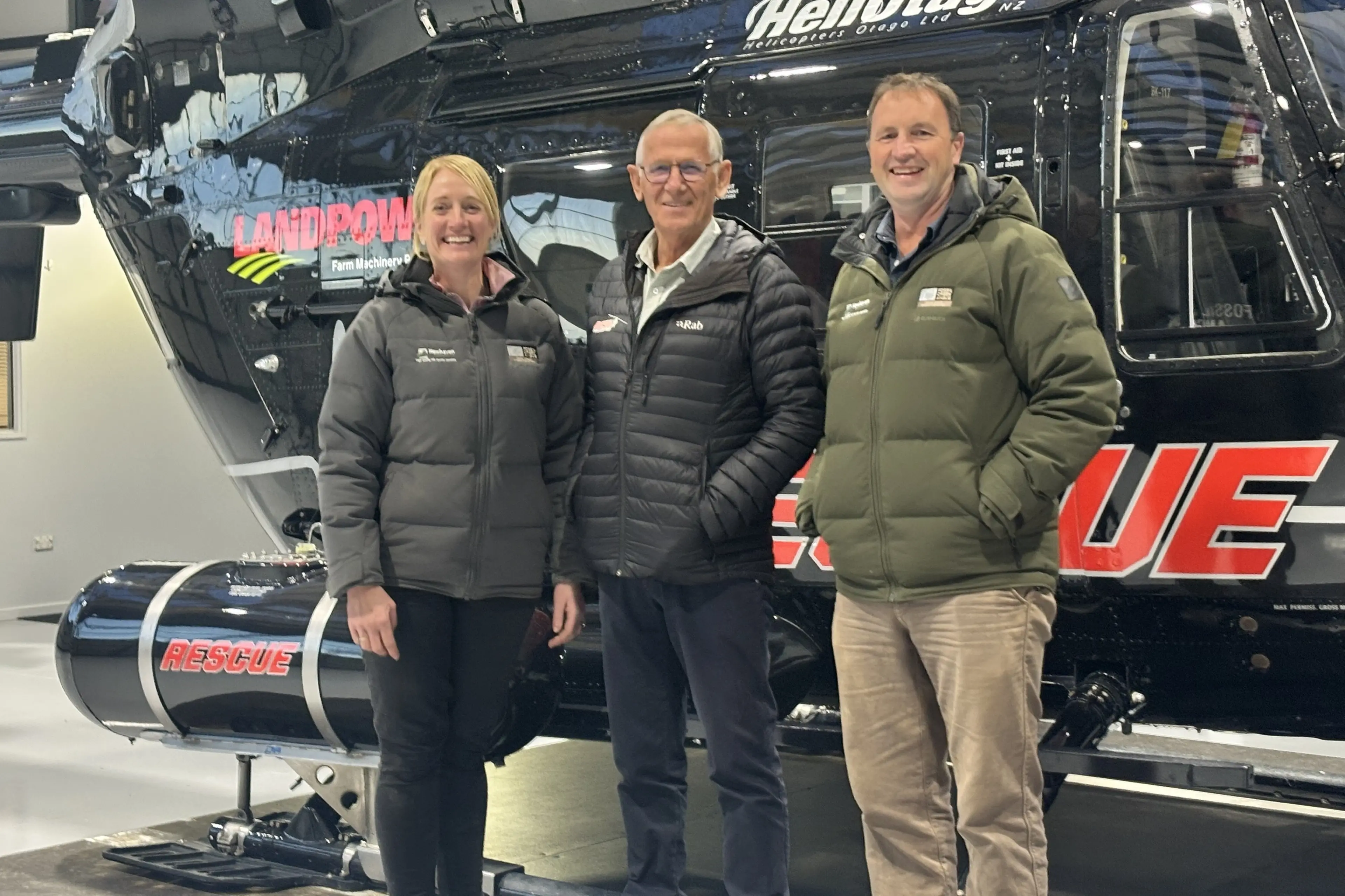 HeliOtago owner Graeme Gale (centre) gave Fossil Creek Angus owners Jane and Blair Smith a tour of the hangar on Taieri Airfield, after the bull breeders gave the Otago Southland Rescue Helicopter Trust a donation from the proceeds from their bull sale. Photo: Supplied