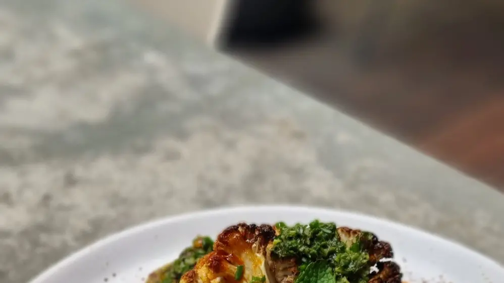 Turkish roasted cauliflower with coconut raita, fresh herbs and chilli oil