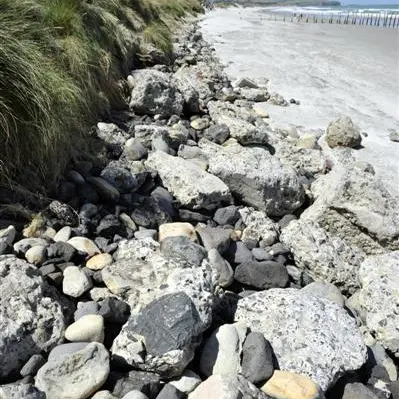 Swells uncover rubble on St Clair beach