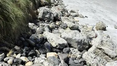 Swells uncover rubble on St Clair beach