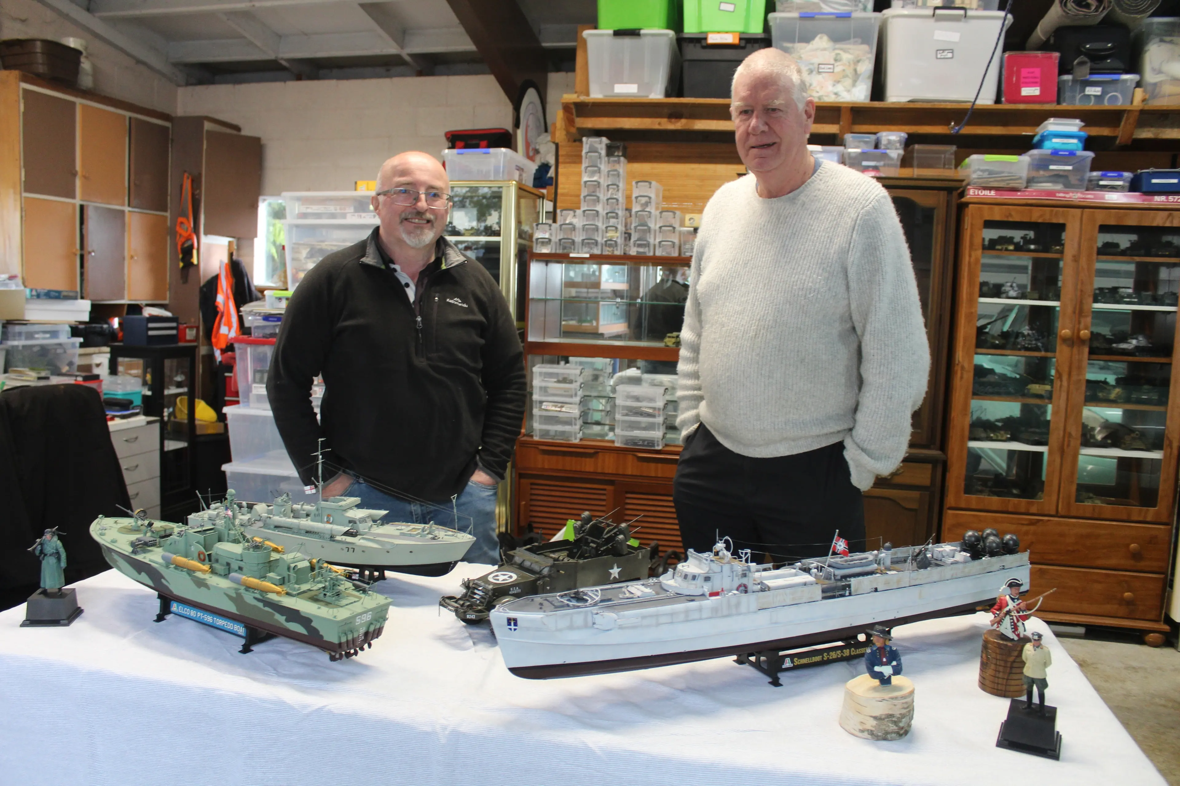 Greg Braddock (left) and Brent Davidson with some naval models in Mr Davidson\\'s garage. Photo: Tayler Mutton