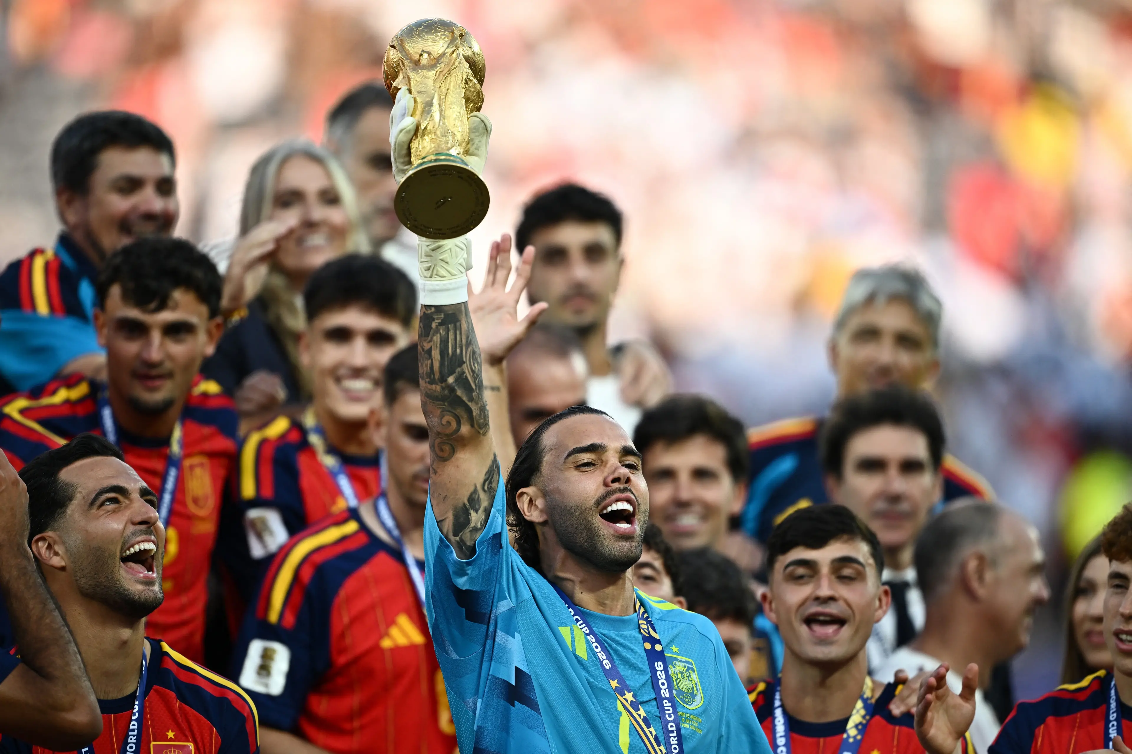 Spain\\'s David Raya lifts the World Cup trophy alongside teammates as they celebrate winning the World Cup. REUTERS/Dylan Martinez