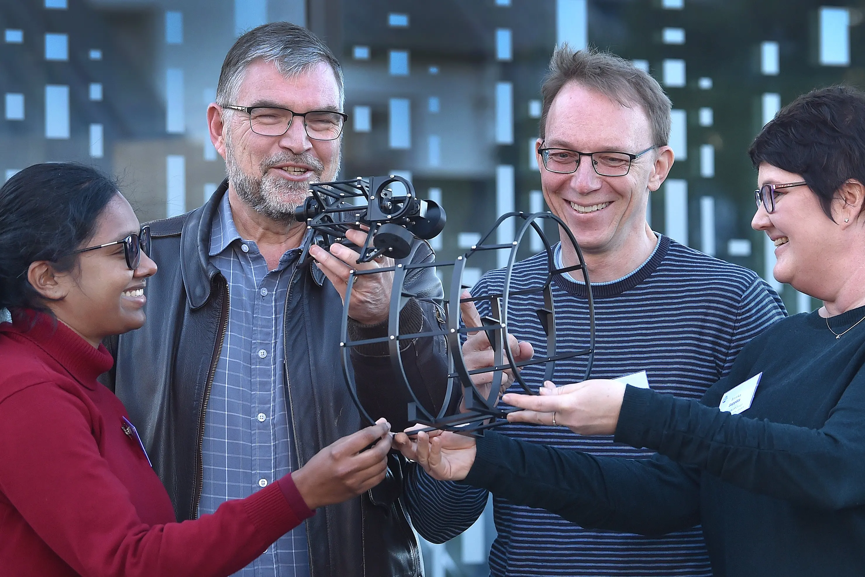 Inspecting part of a prototype weather satellite are (from left) University of Otago physicist Dr Mallika Suresh, Victoria University of Wellington space research chief scientist/engineer Prof Randy Pollock, and University of Otago physicists Prof Harald Schwefel and Annika Seppala, who are among a large group of authorities from around the globe working on the project. Photo: Peter McIntosh