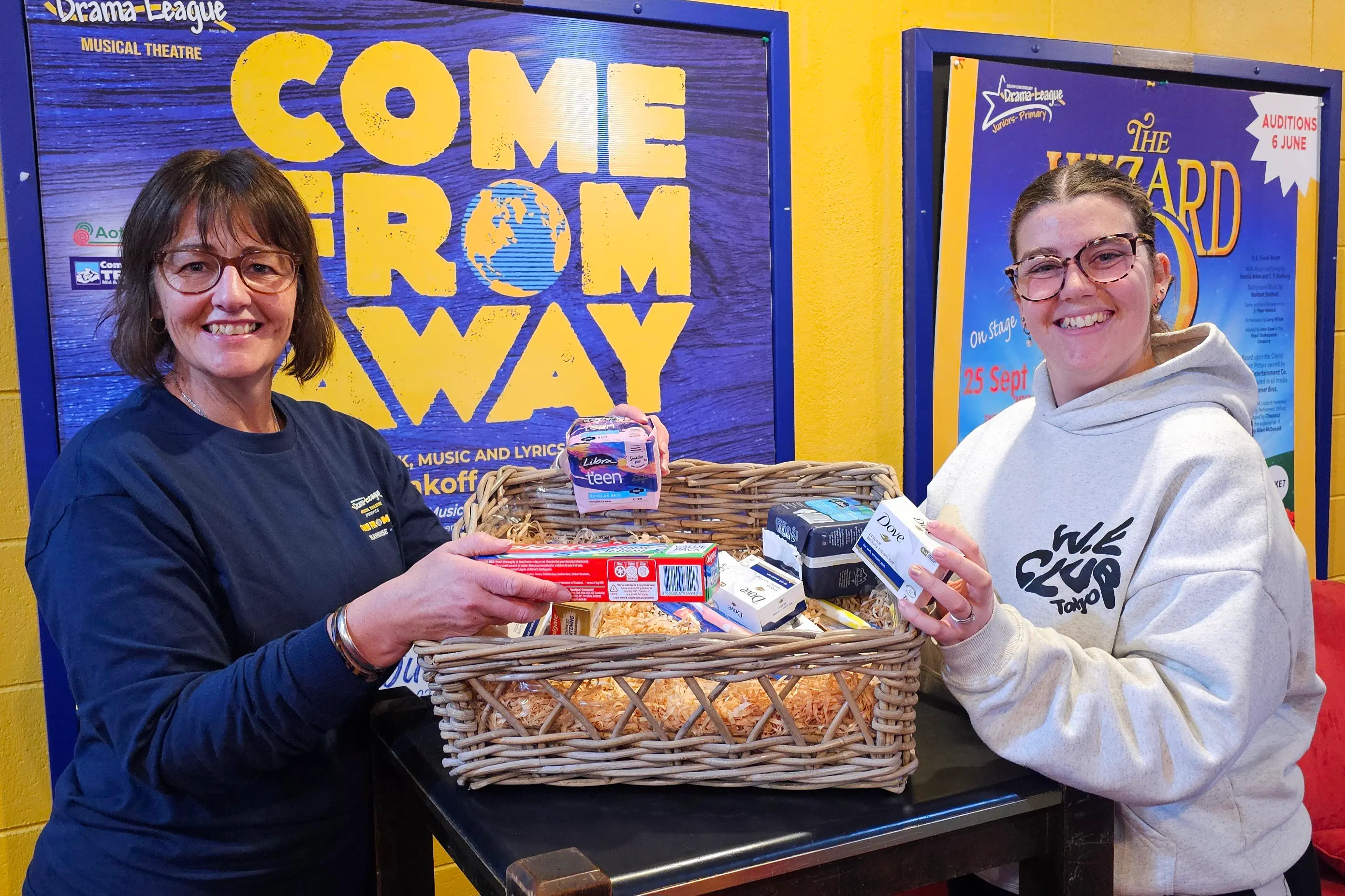 Showing off some of the items that audiences can donate are front of house staff Sharon Brown (left) and Emma Robb. Photo: Connor Haley