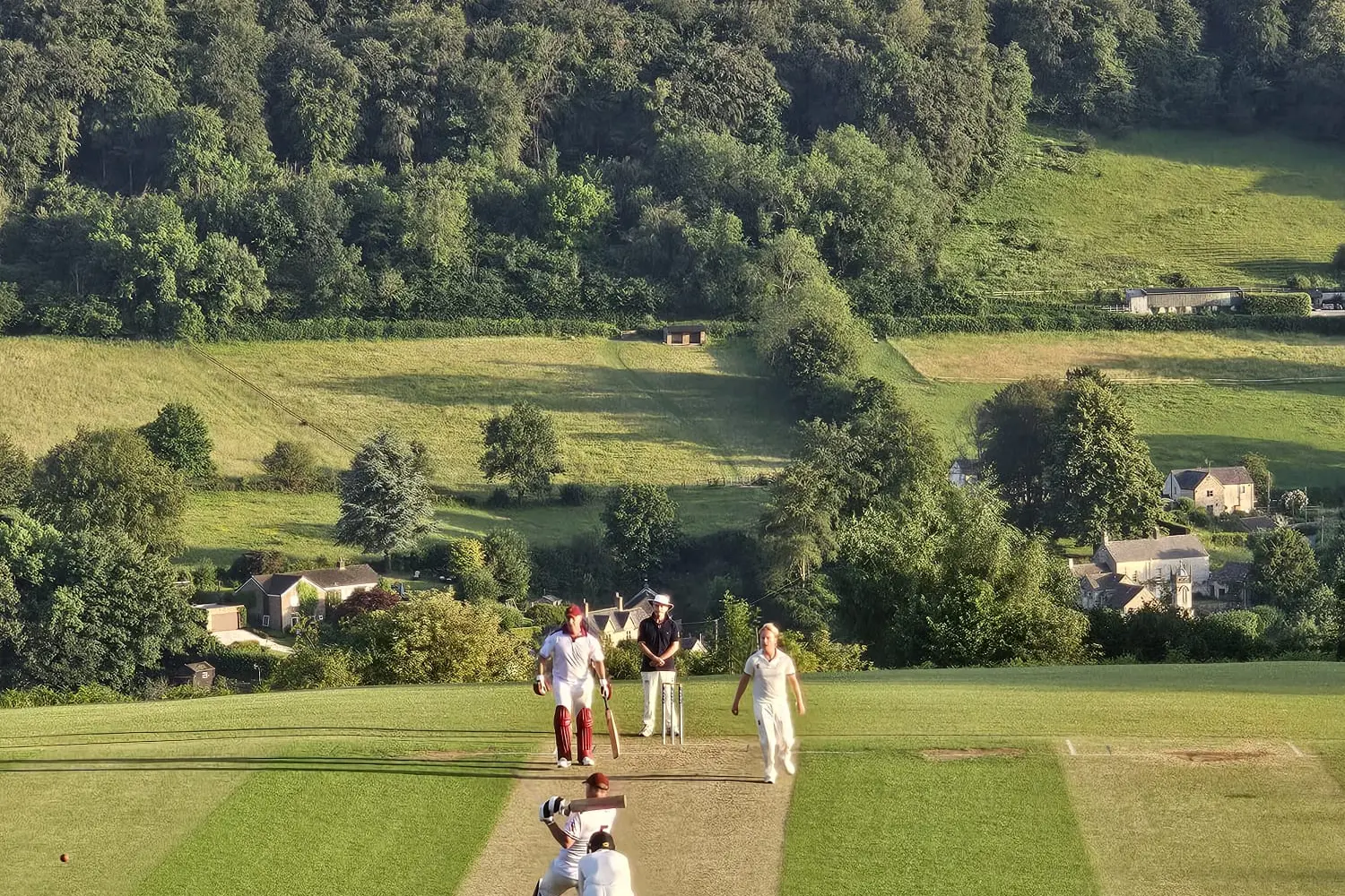 What a classic: Southland Development Squad batter Charlie Phillips, watched by Jono Browne, pulls the ball during a game at England\\u2019s Sheepscombe Cricket Club, whose ground\\u2019s notable for a very steep drop-off. Photo: Supplied
