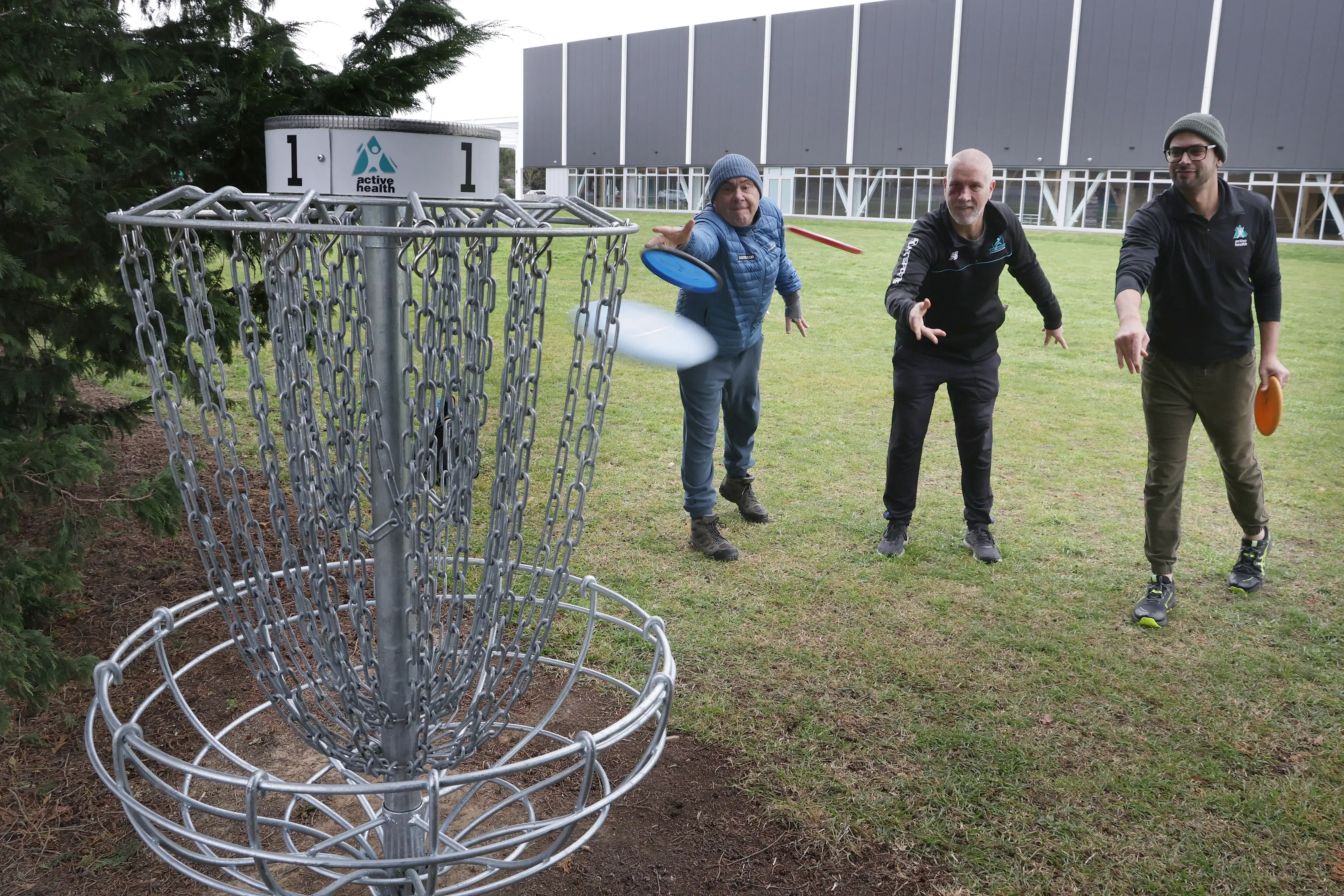 Success . . . Reaching the basket on the first hole of the nine-hole Rangiora Disc Golf Course were (from left) Andrew Smith, Tony Kean and Kirwan Franke. Photo: John Cosgrove