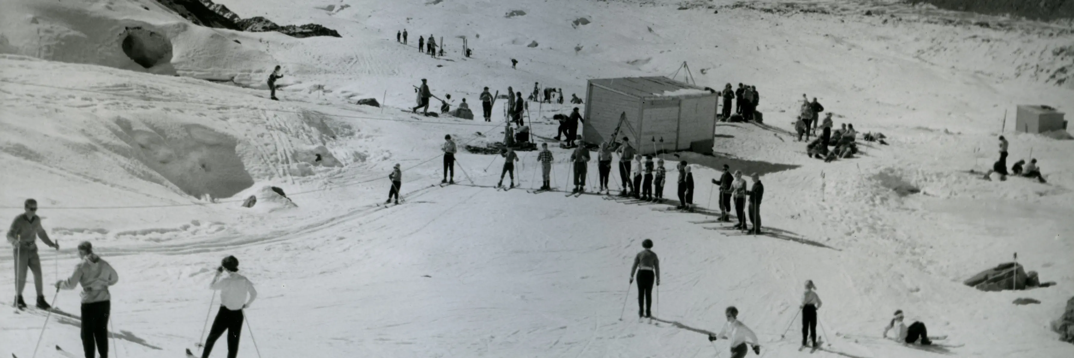 Skiers using a rope tow installed on the Ball Glacier in the late 1950s, with Tasman Glacier in the background. Photo: South Canterbury Museum