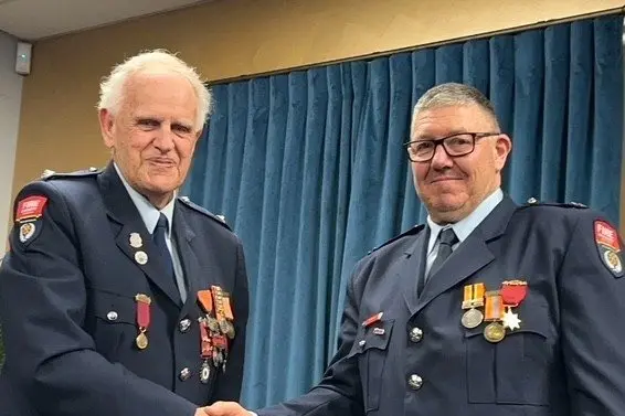 Ashburton Volunteer Fire Brigade chief fire officer Alan Burgess, at left, presented Jeff Whyte with his 25 years of service gold star at the Pendarves Station last week. Photo: Supplied