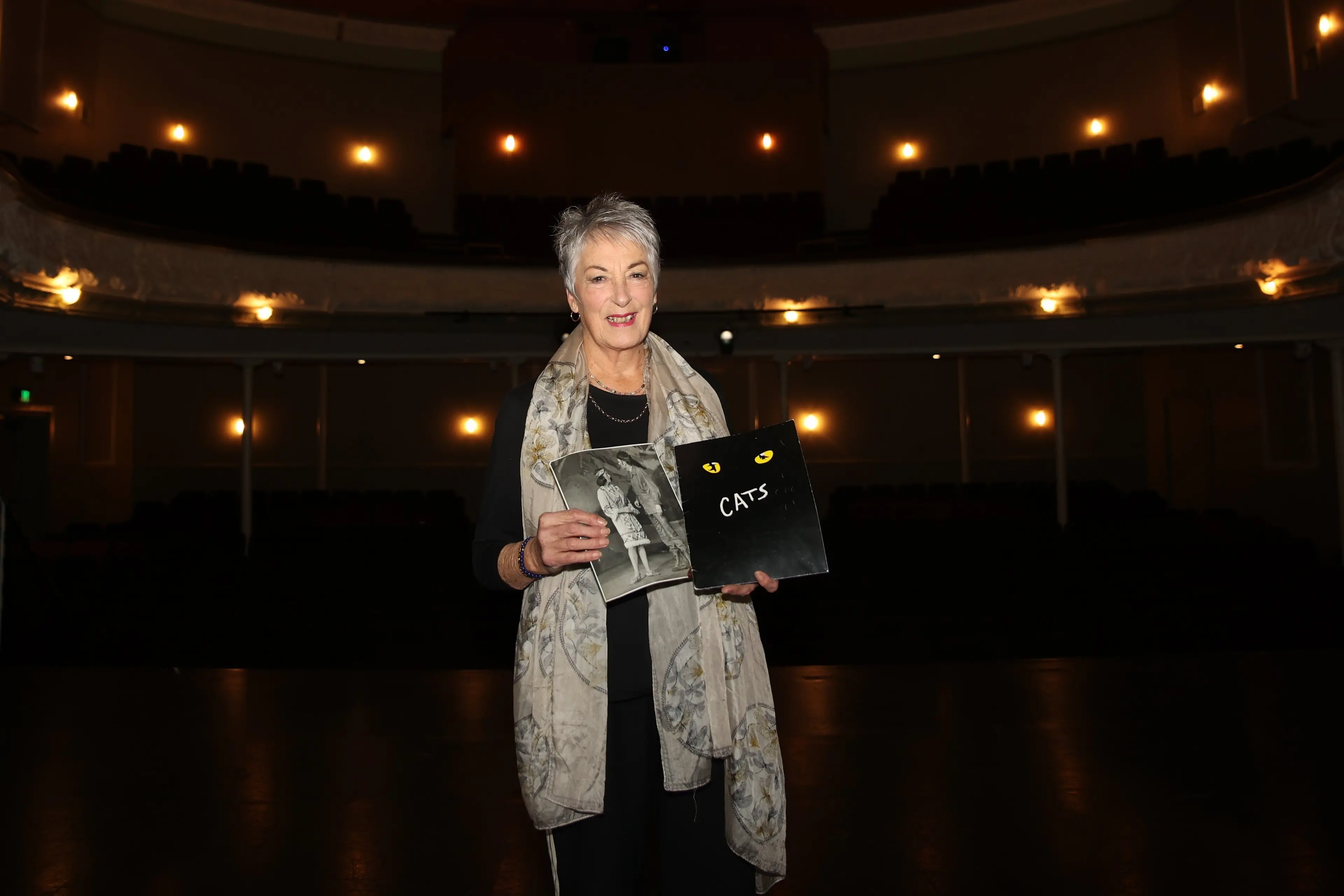 At the Oamaru Opera House is Ann Willetts holding a photo when she was on stage for Musical Theatre Oamaru\\'s 1967 production of \\'Rose Marie\\', and the programme for the production of Cats in 2009, both shows she was a cast member in. Photo: Supplied