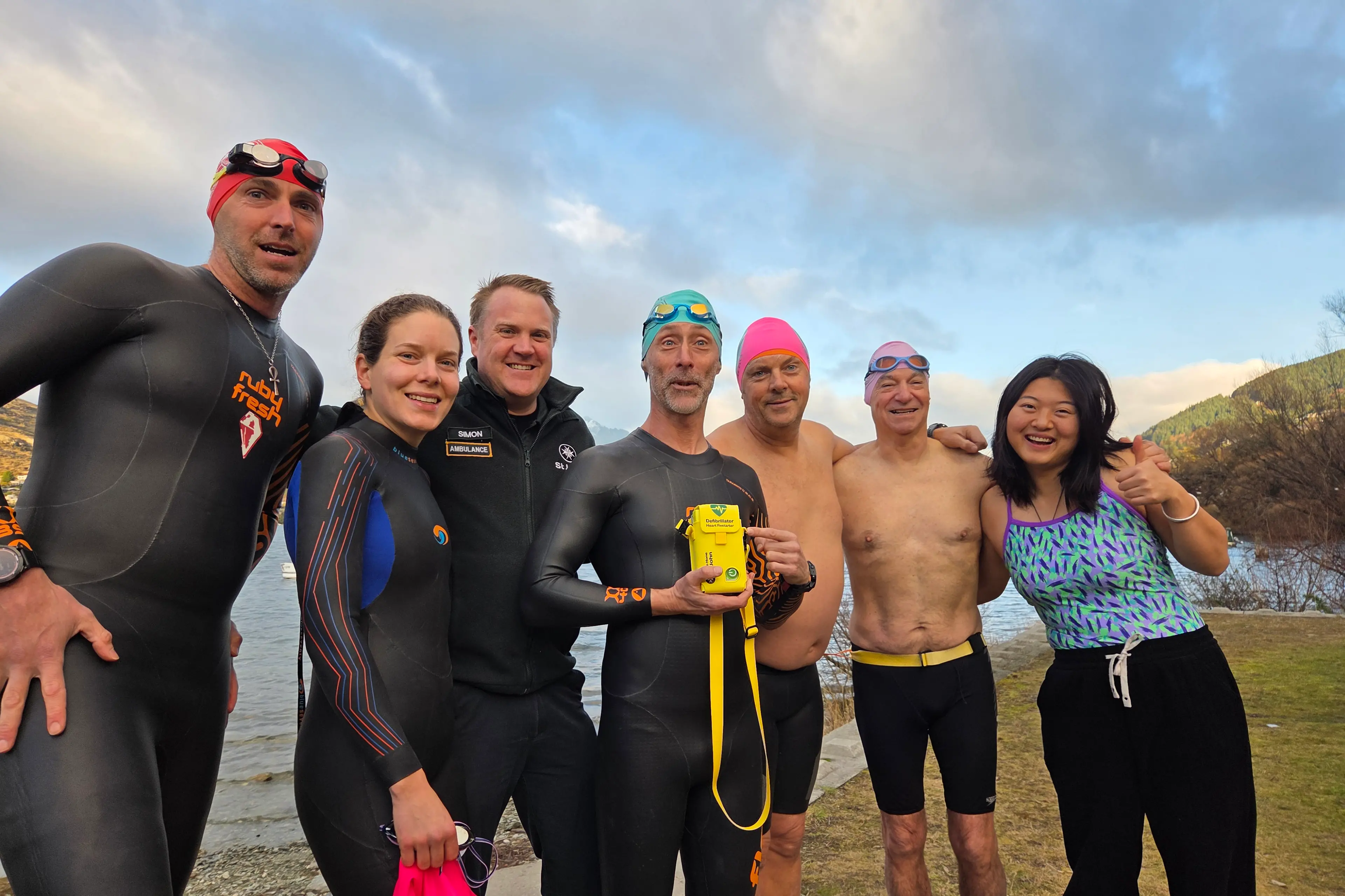 Next-gen life-saving: Southern Lakes Swimming Club founder Richie Lambert, centre, holds the club\\u2019s new LifeBeat Mini Defibrillator. Photo: Supplied