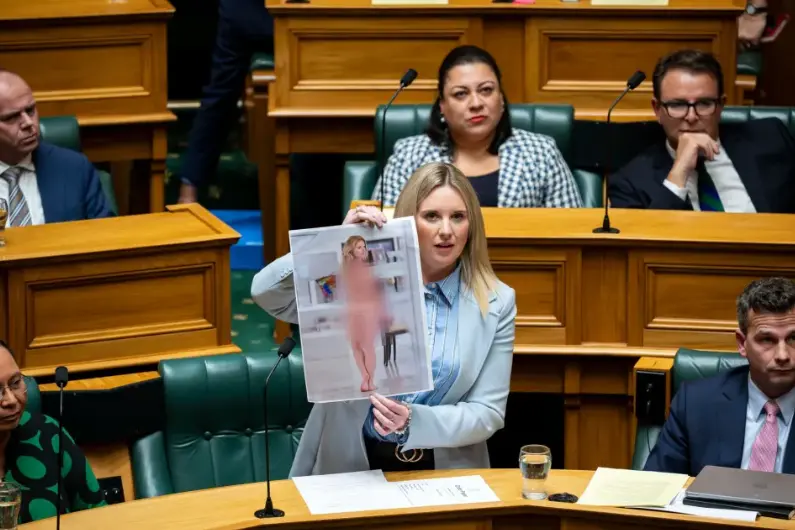 ACT MP Laura McClure shows Parliament a fake nude photo of herself she created when her bill was first drawn in June last year. Photo: Facebook / Laura McClure