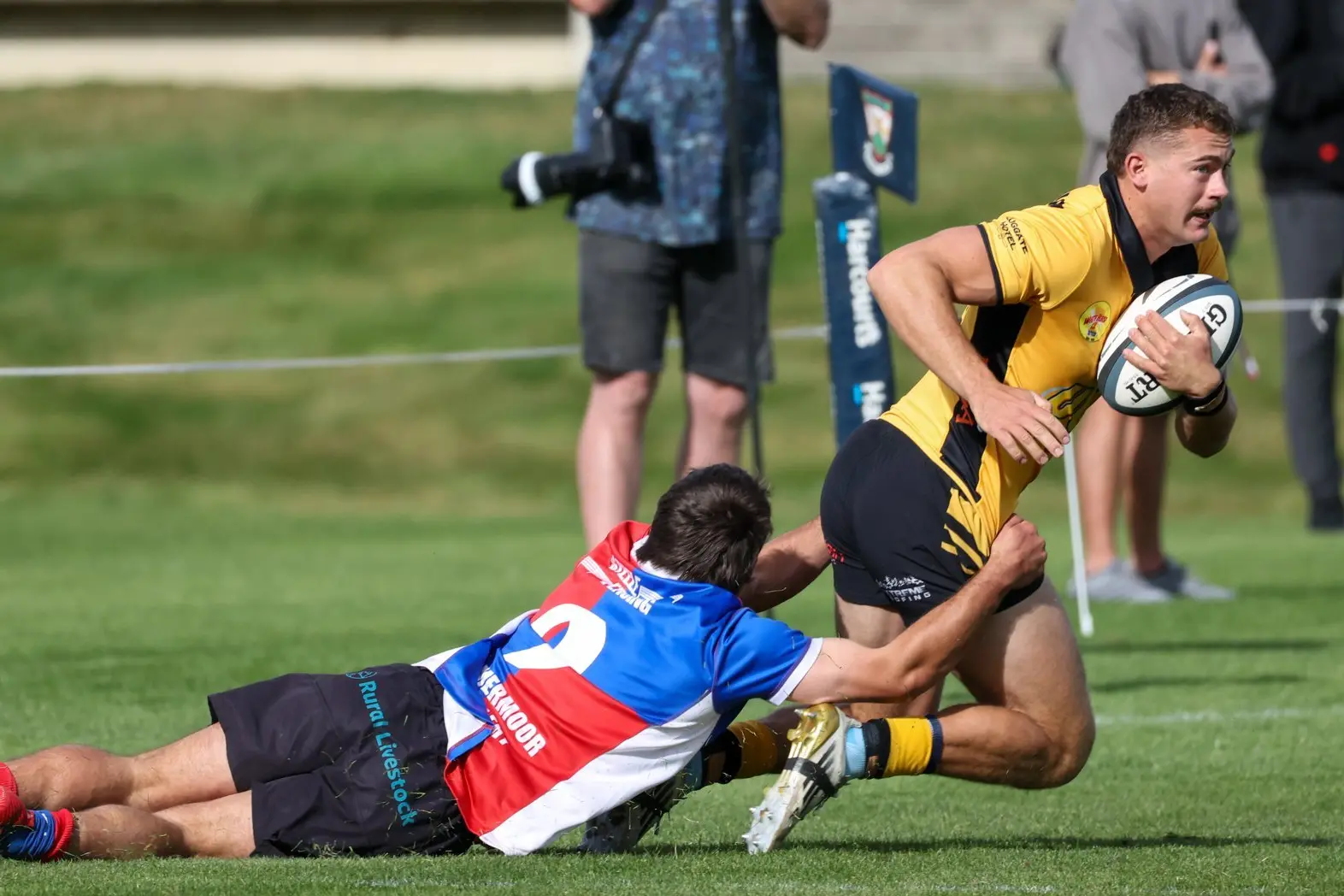 Upper Clutha winger Jack East, pictured trying to slip away from Maniototo halfback Ben Maxwell earlier this season, has been in fine form for the defending Central Otago club champions. Photo: Richard Jones