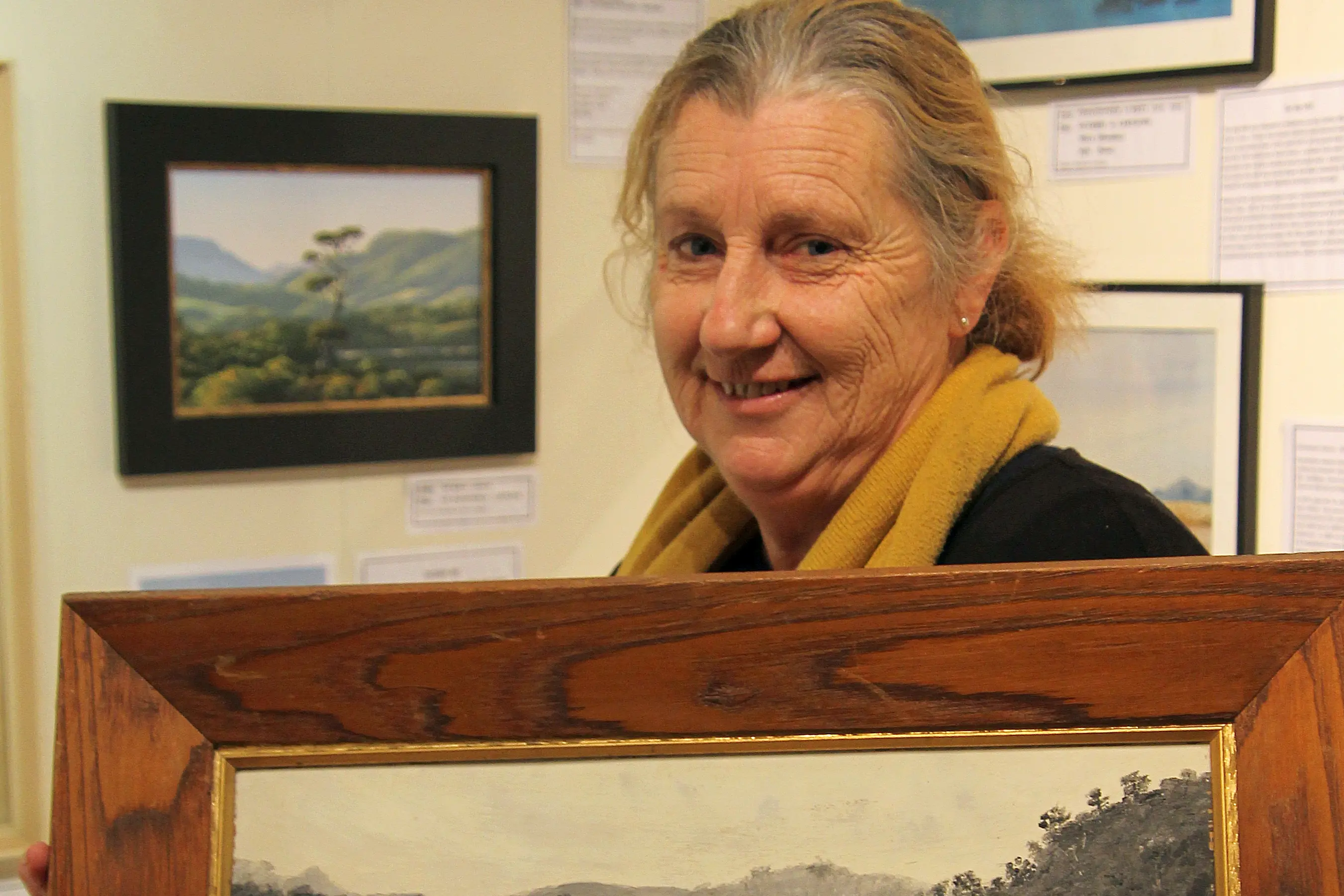 Artist Marie Reid holds Duttons Rd below Dutton\\u2019s Bridge by Caroline Dutton (1864-1958), at Owaka Museum\\u2019s new \\'From Our Archives\\' exhibition. Photo: Nick Brook