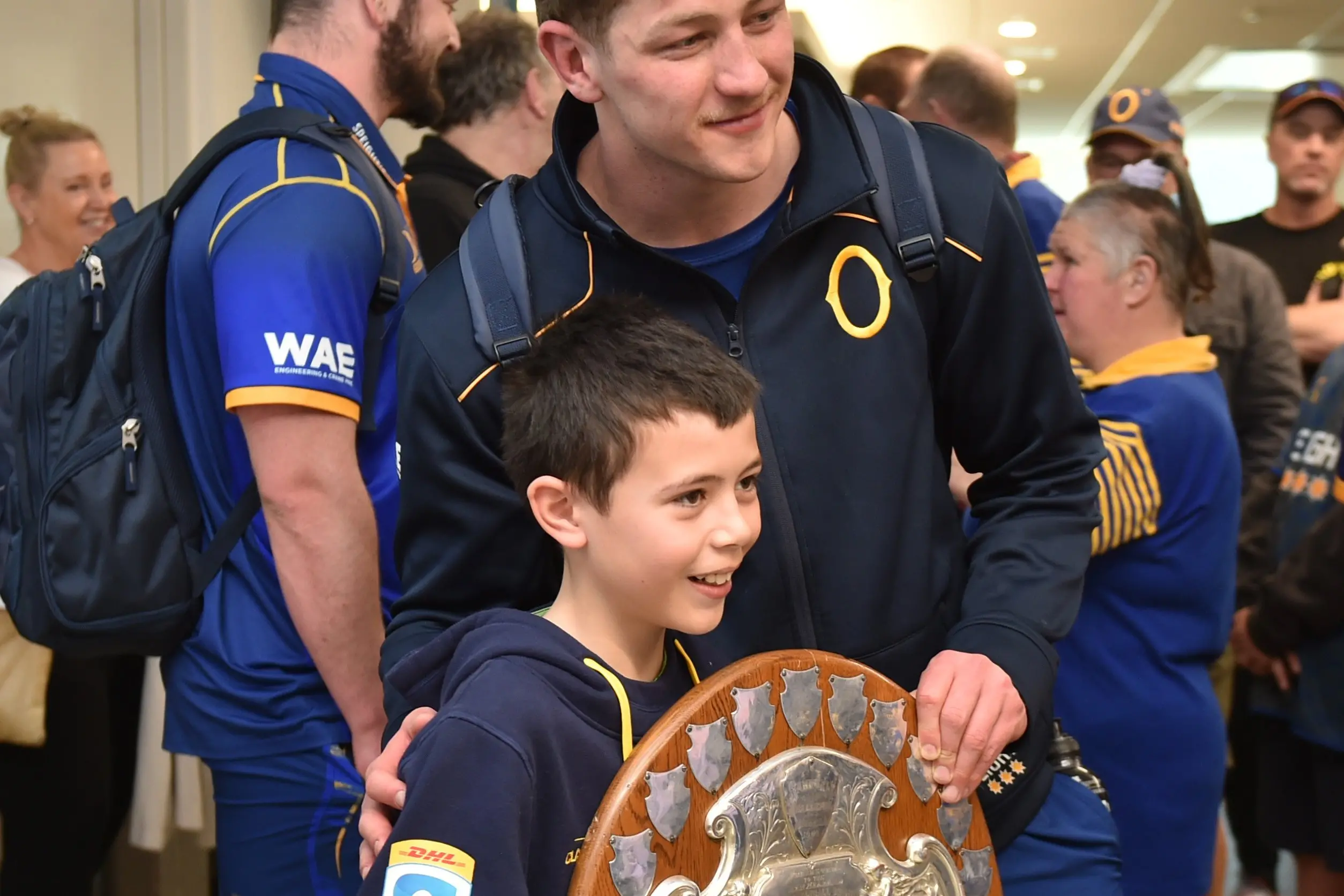 Star Otago loose forward Lucas Casey poses for a photograph with fan, Lachie Nooroa, and the Ranfurly Shield. Photo: Gregor Richardson