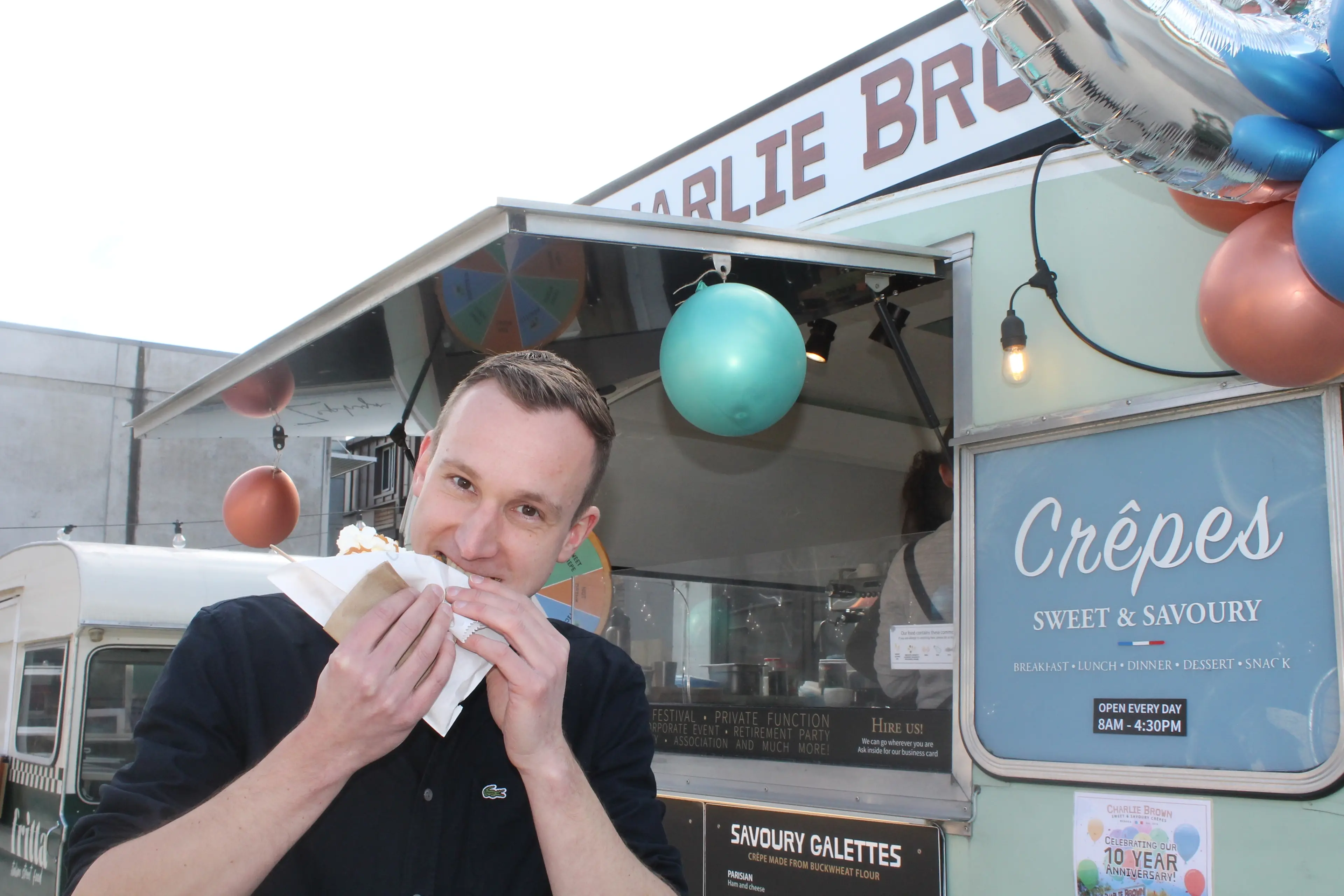 Charlie Brown crepe owner Adrien Paoli takes a bite out of the a popular crepe as his business celebrates 10 years of operation. Photo: Evie Sinclair