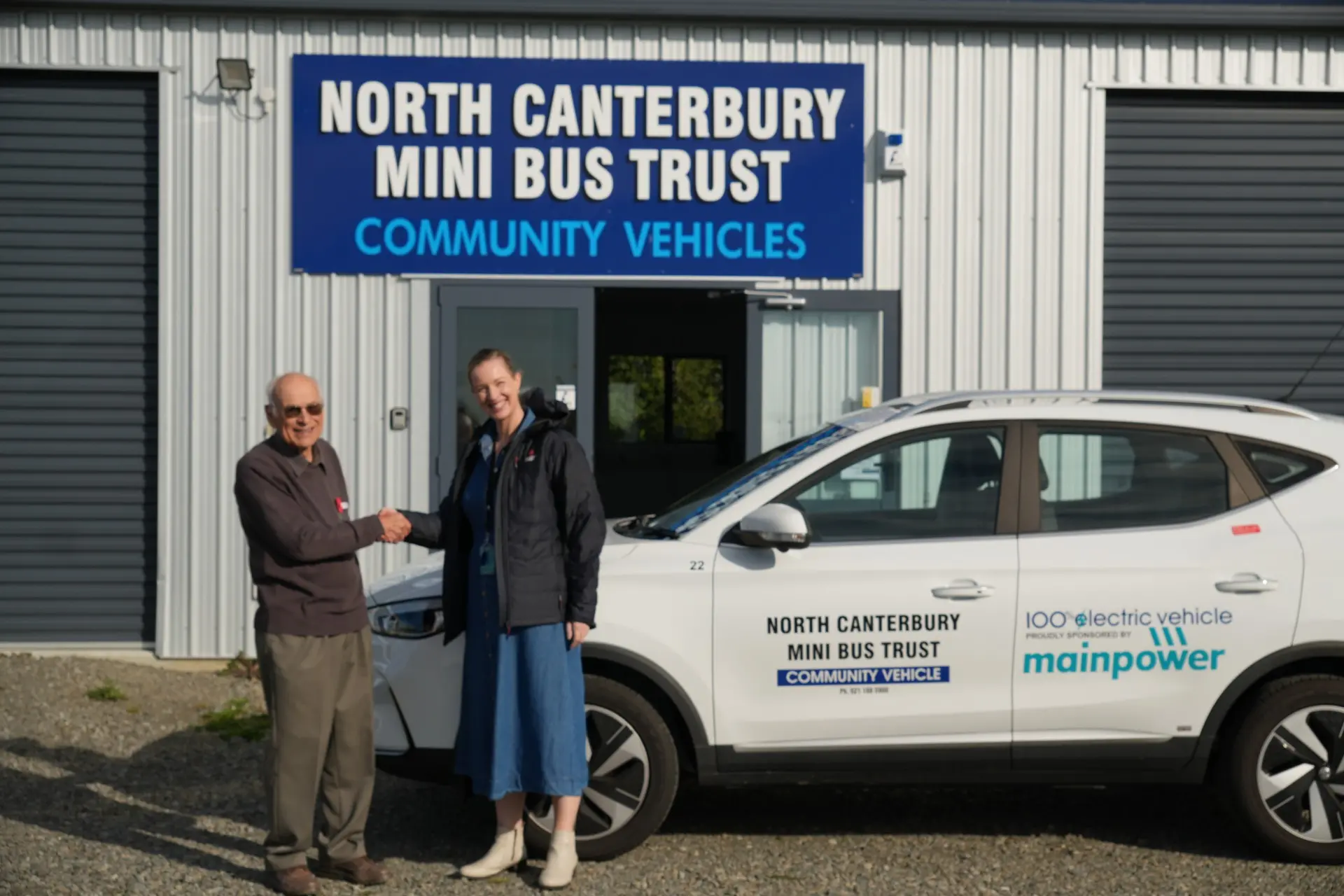 Celebration time . . . Don Fairbrother, from the North Canterbury Mini Bus Trust meets with MainPower General Manager Customer Corporate Relations, Penny Kibblewhite, to celebrate a new EV for the North Canterbury Vehicle Trust, funded by MainPower Decarbonisation Funding. Photo: Supplied