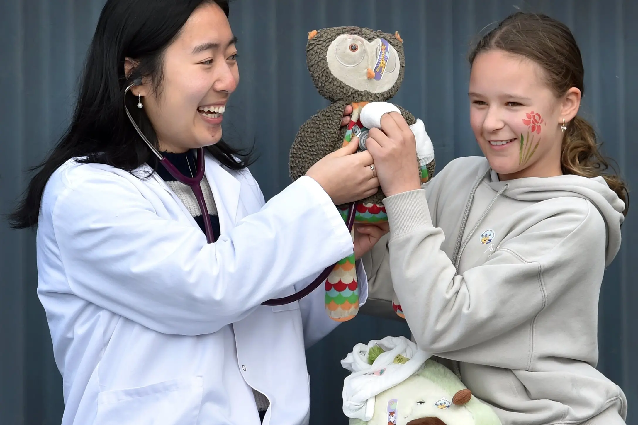 Otago University Medical Students\\' Association community outreach organiser Nadia Zhou checks on Millie Walters\\', 10, beloved stuffed animal during the Teddy Bear Hospital at Carisbrook School on Saturday. Photo: Peter McIntosh