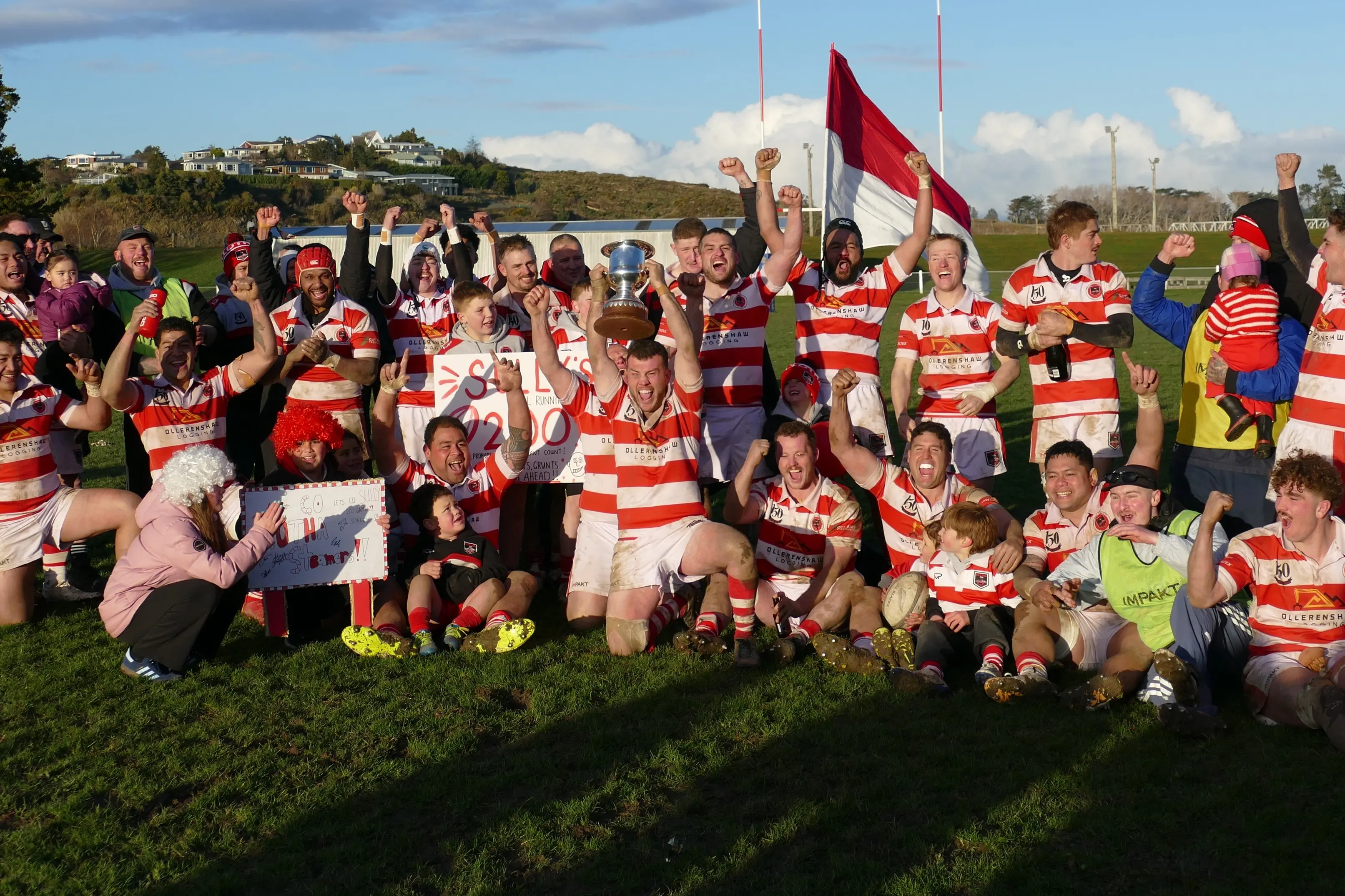 Clutha Steamers captain Max Pennell holds the Southern Region trophy aloft as the team celebrates retaining the title against West Taieri, at the Balclutha Showgrounds on Saturday. Photo: Richard Davison