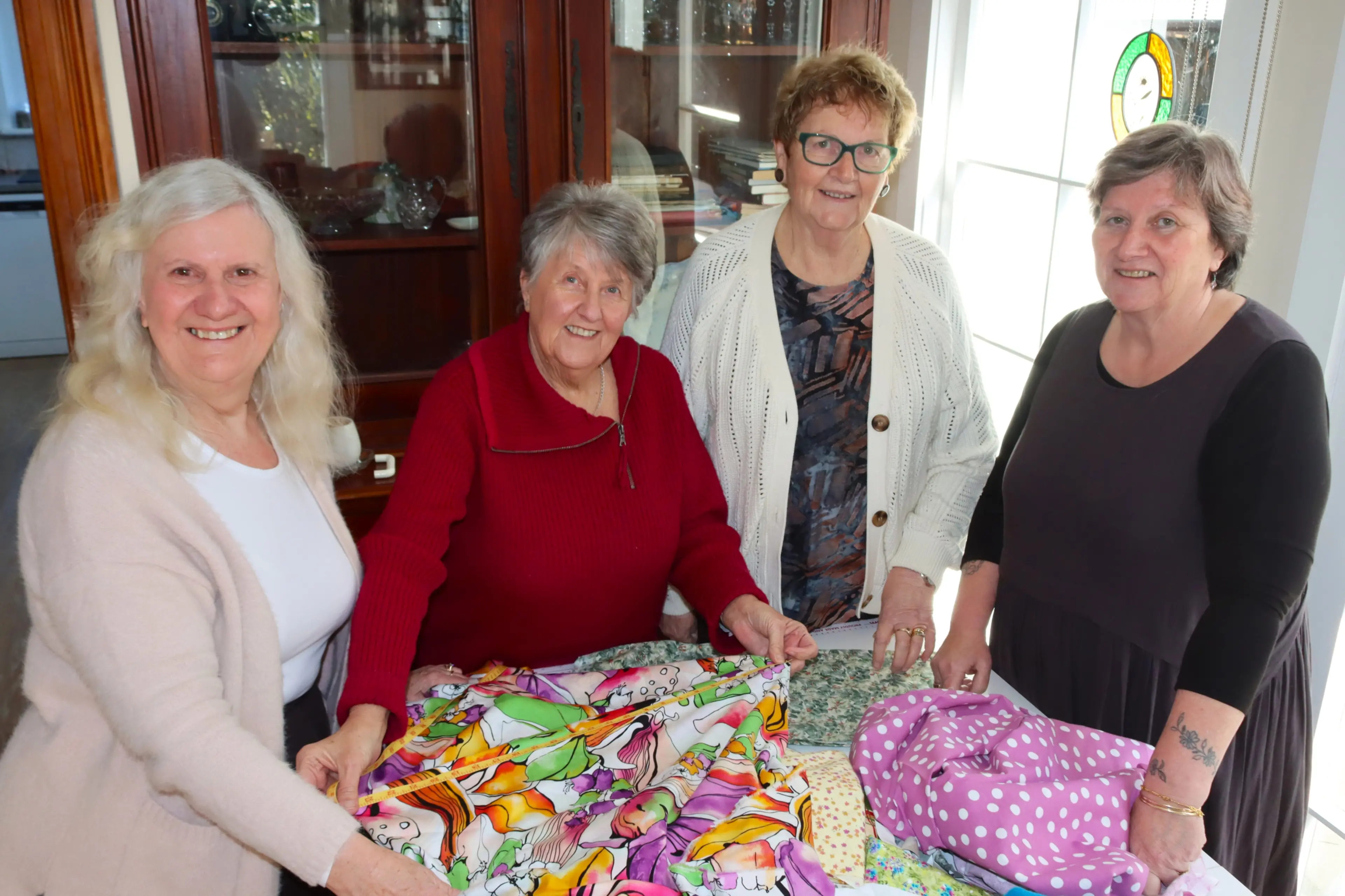 Fabric-A-Brac Dunedin committee members (from left) Amanda Tonks, Rosemary Tarbotton, Ngaire Patterson and Merridee Watson measure and sort fabrics for the organisation\\'s third event coming up in August. Photo: Sam Henderson