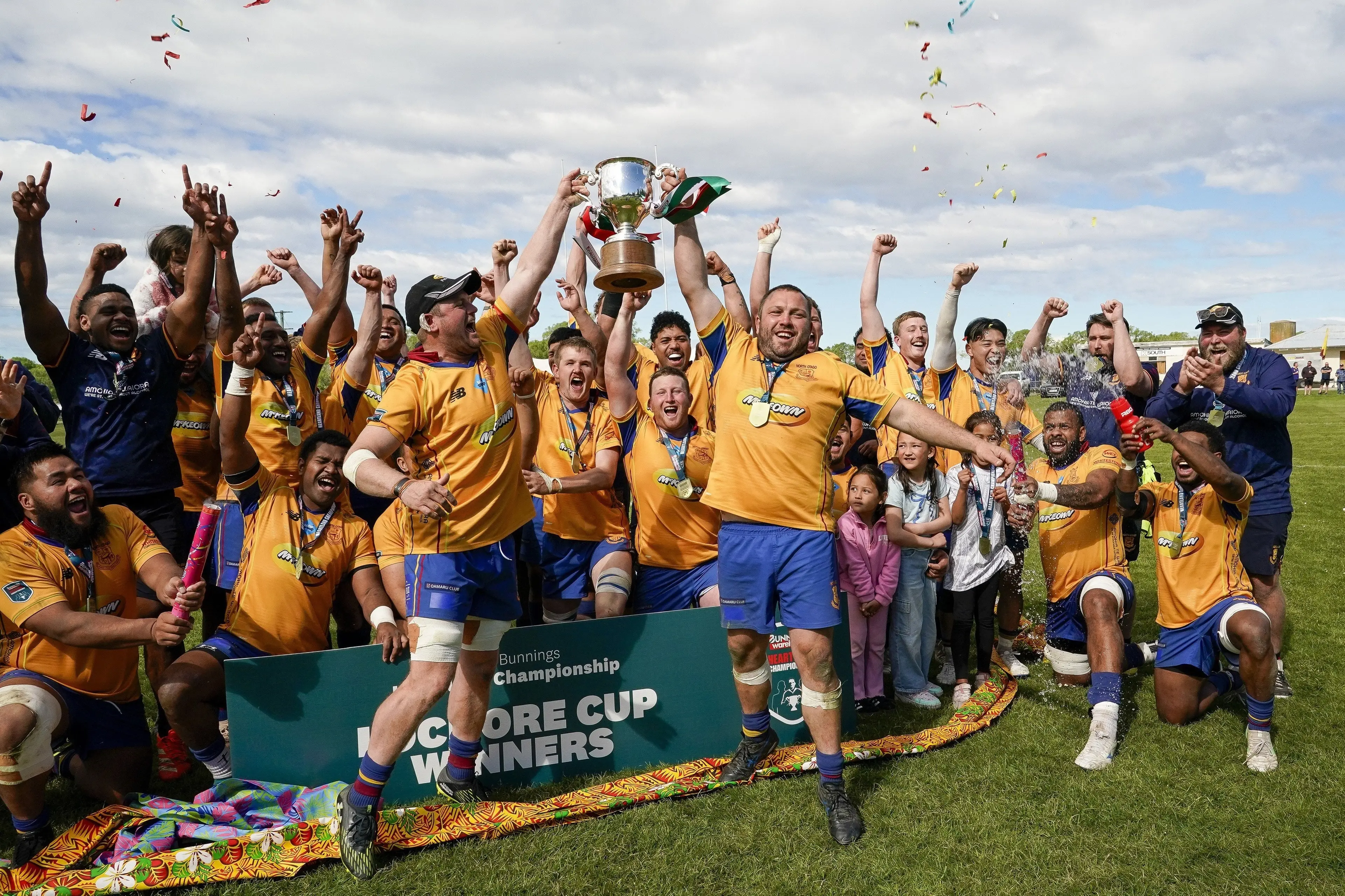 Cameron Rowland (left) and Hayden Tisdall lift the Lochore Cup after leading North Otago to the title in Maheno last year. Photo: Michael Thomas/Action Press