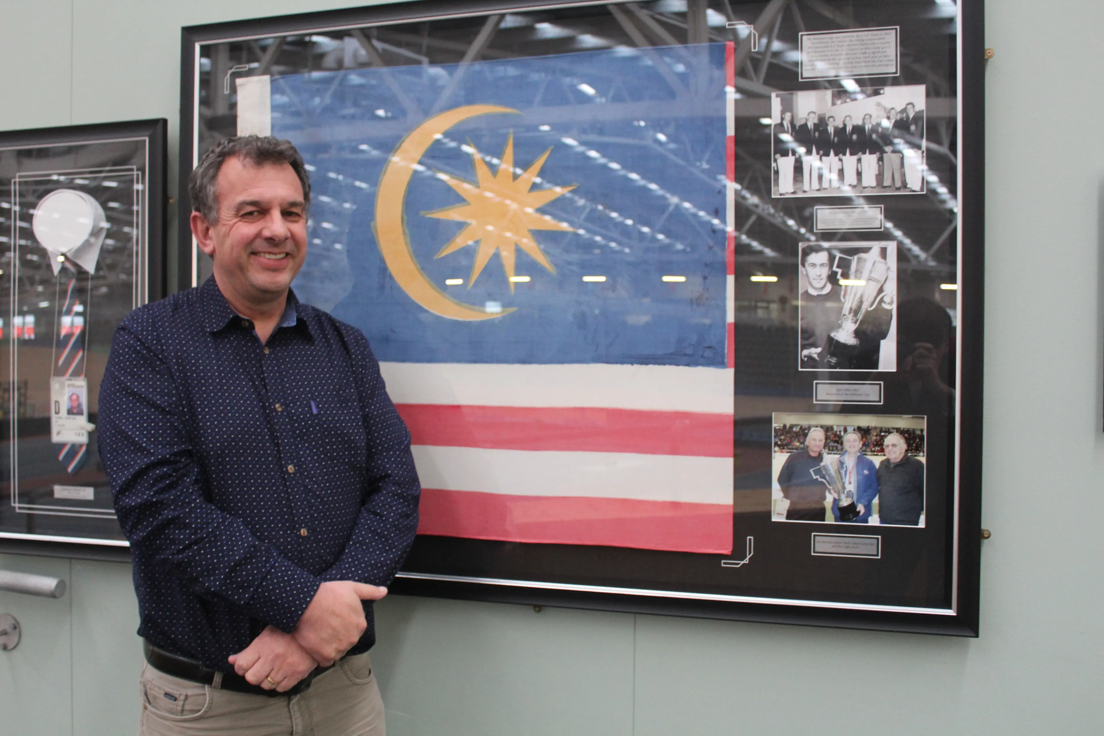 Cycling Southland president Julian Ineson with the Malyasian flag signed by the New Zealand team first to compete for the Malayan Cup. Photo: Tayler Mutton