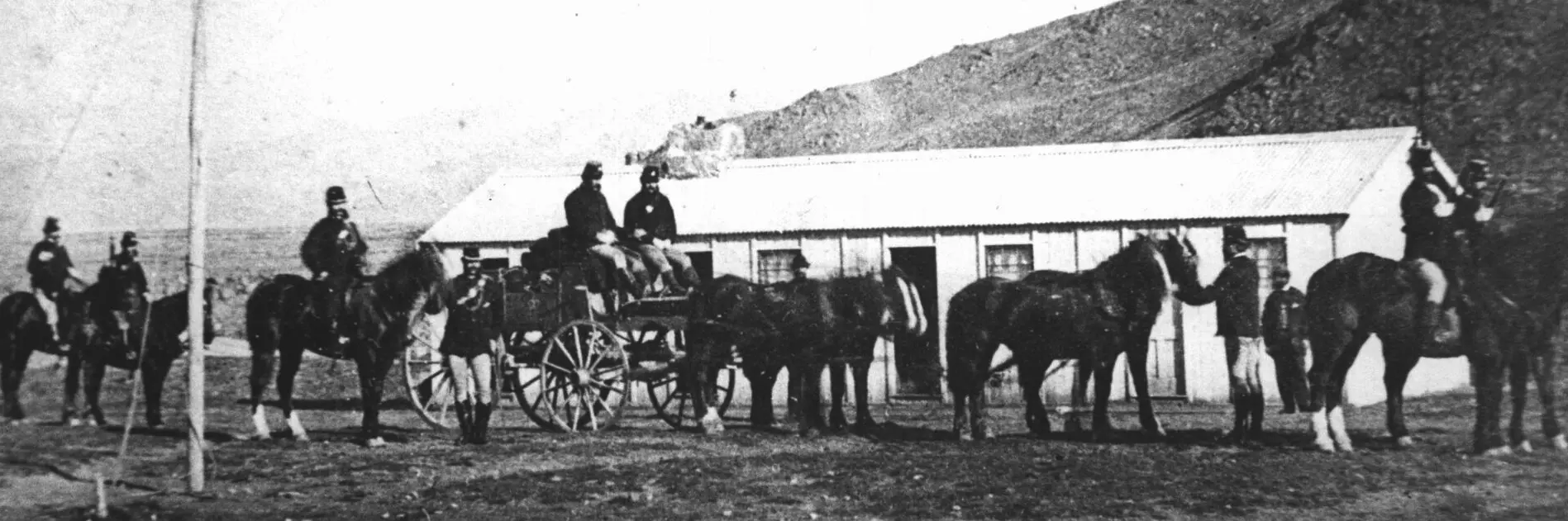 Armed gold escorts carried gold from the Otago goldfields to banks in Dunedin in the 1860s. This escort, armed with carbines, revolvers and sabres, is leaving Clyde in Central Otago for Dunedin. Photo: Hocken Digital Collections, Ref: NEG/SHEET24/4/6