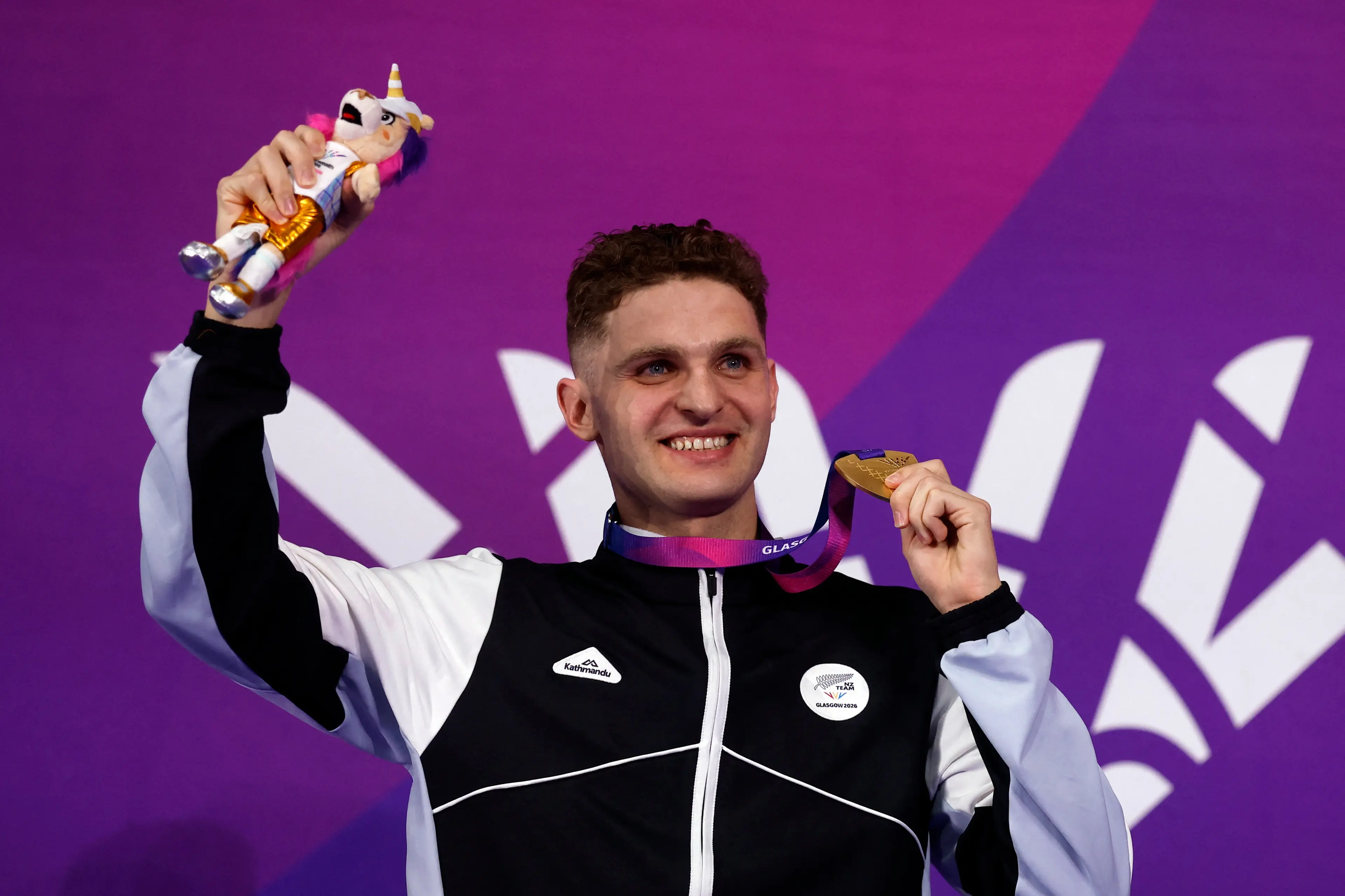 Lewis Clareburt celebrates on the podium after winning the men\\'s 200m butterfly final. Photo: Reuters