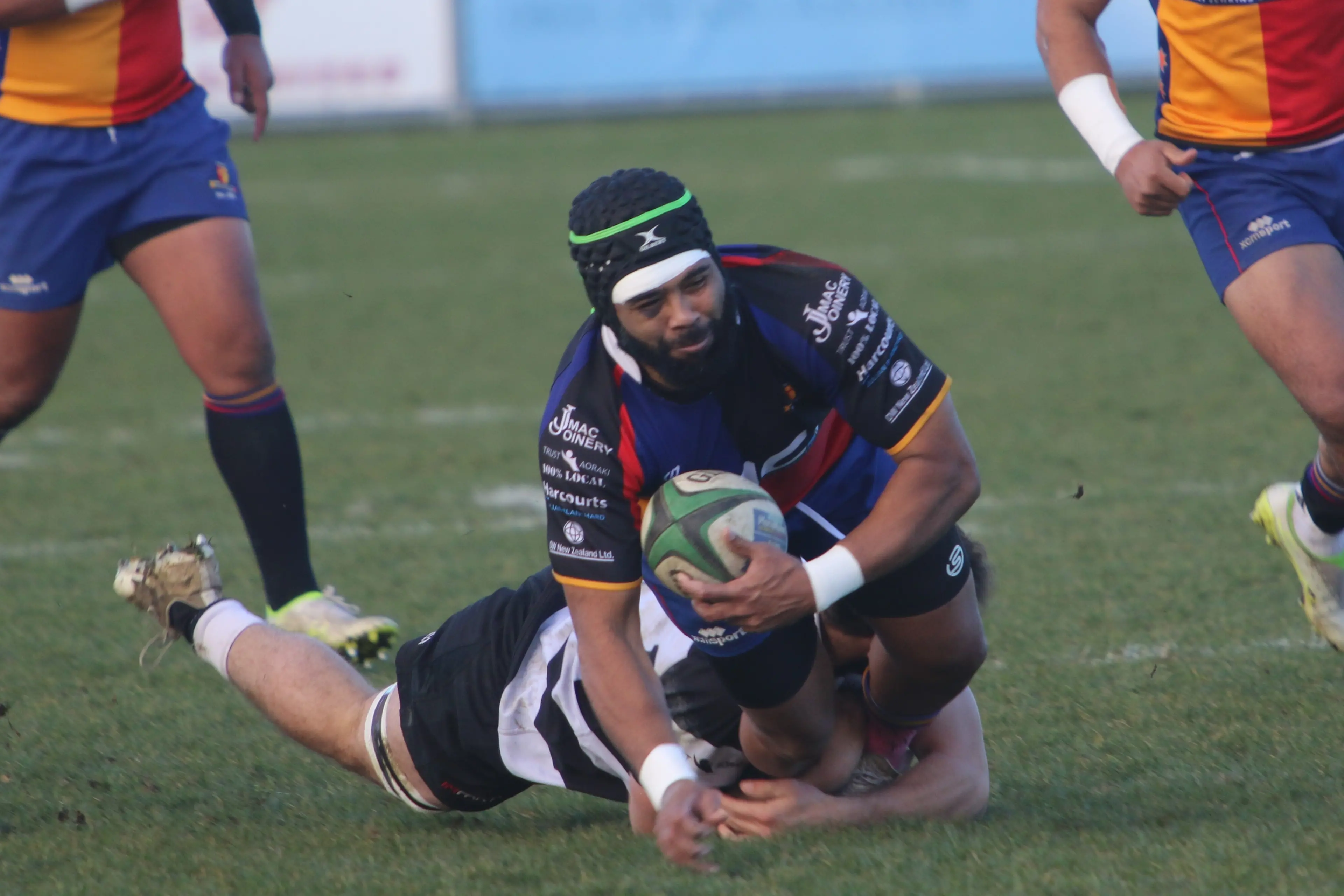 Harlequins lock Leone Nawalu is wrapped up in a strong tackle. Photo: Stu Piddington