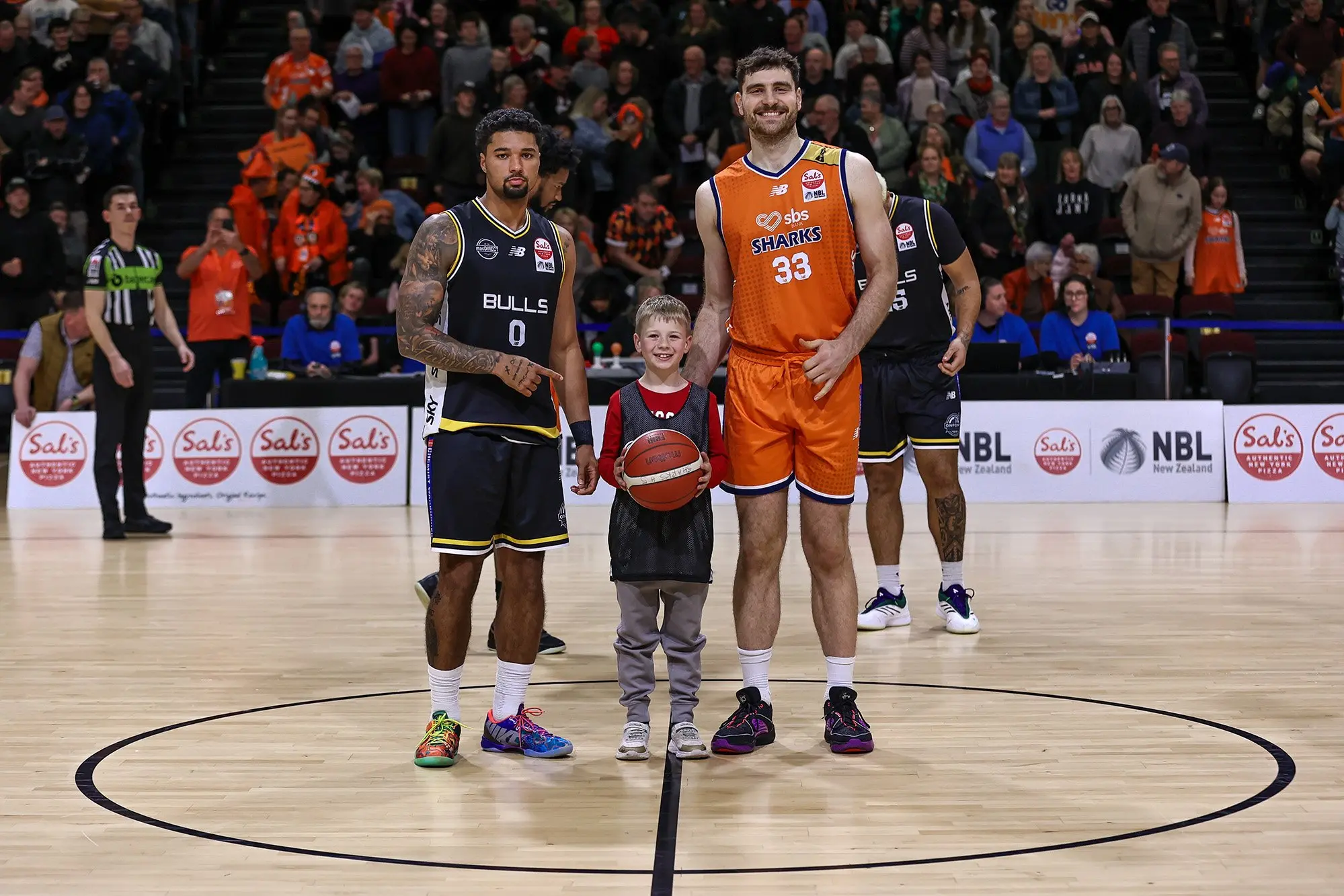 Southland Stags captain Sam Timmins and Franklin Bulls captain Jace Carter with a young fan at the Shark Tank earlier this season. Photo: Monica Toretto.