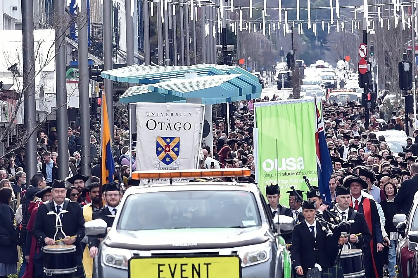University of Otago graduands are escorted by a  police car in a graduation ceremony. The university is targeting a cohort of US Community College graduates to study at Otago.