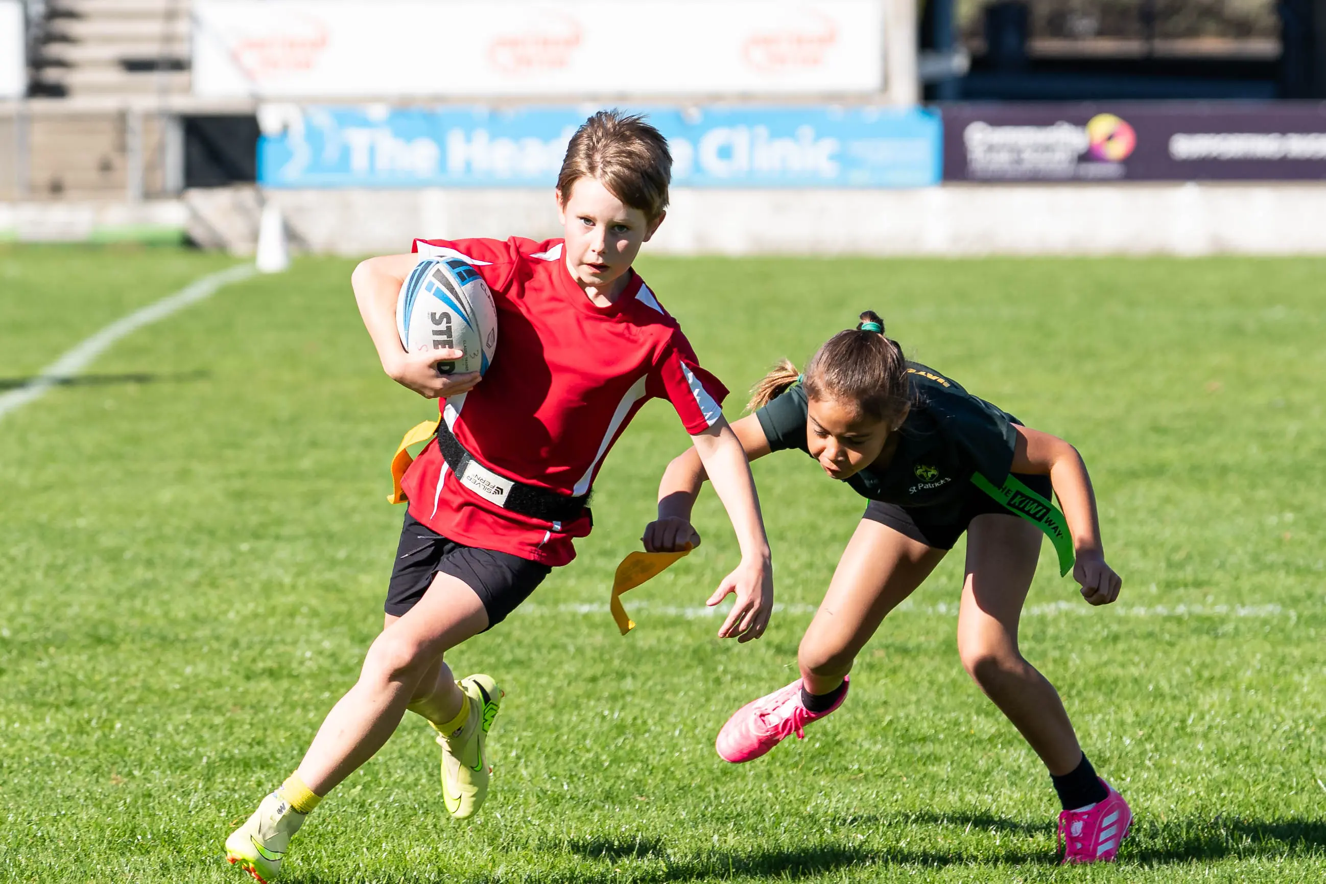 Taking part in the tag rugby league competition held earlier in the year is Cole Auld,10, attempting to evade the tackle of  Phoebe Koro, 9. In September, the players will have the opportunity to take part in a primary school tackle league tournament hosted by Southland Rugby League at Invercargill\\'s Rugby Park. Photo: Supplied