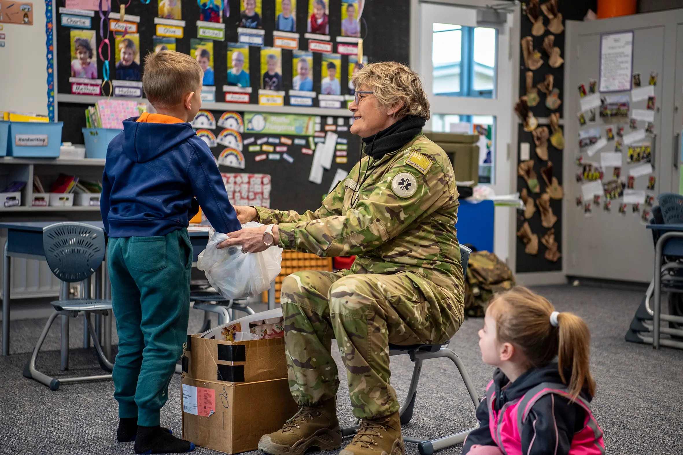Choosing an item from Royal New Zealand Dental Corps reservist dental hygienist warrant officer class 1 Denise Mariu\\'s goodie bag during a talk about looking after teeth is Riversdale School student\\u00A0Colton Govan,6. Watching is Charlotte Coughlan, 5 also from Riversdale. Photo: Supplied.