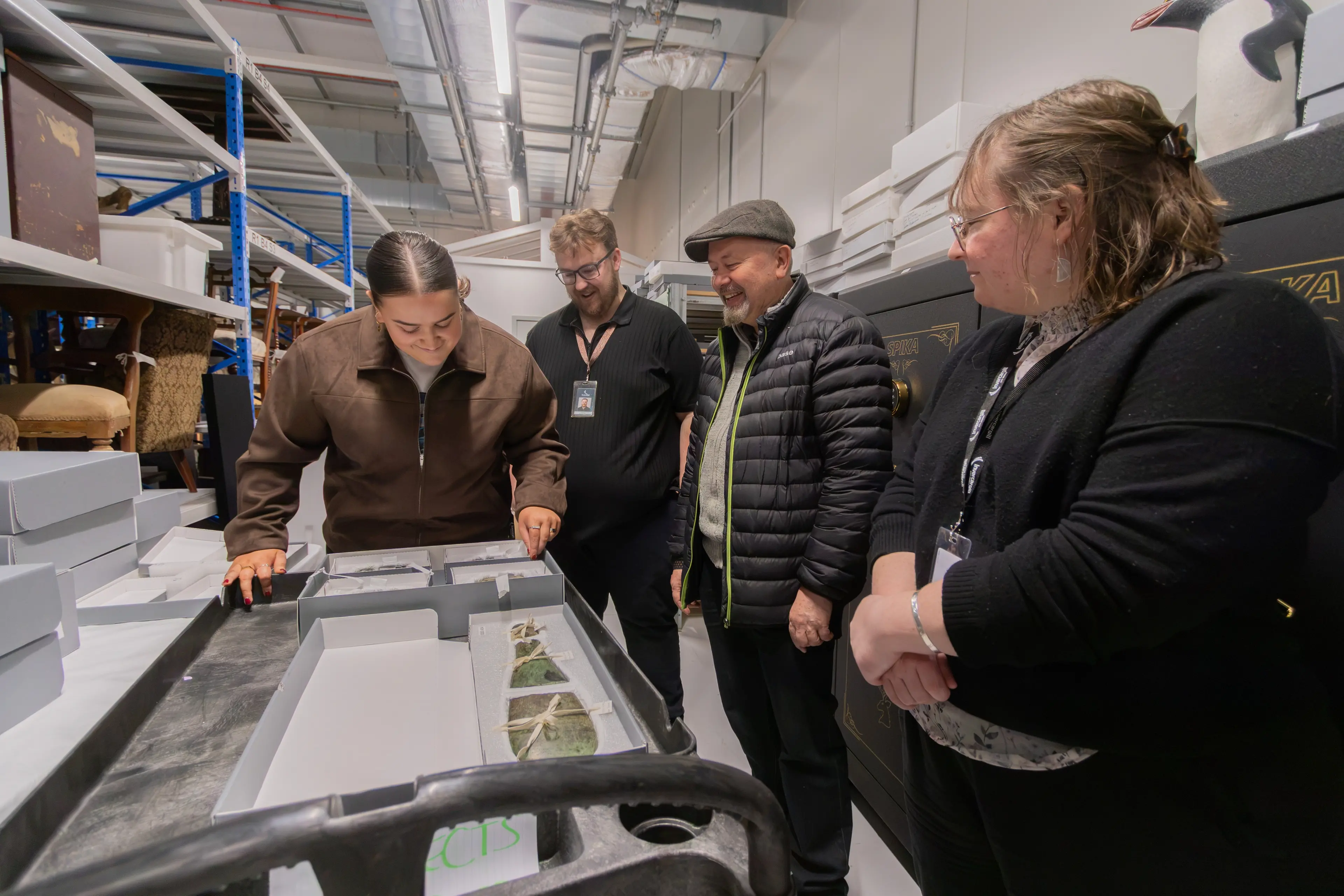 Te Unua Museum of Southland staff (from left), Tyra Ryan (Kaitiaki Mana Taoka), Ayden Dove (Registrar), Dougal Austin (Senior Curator \\u2013 M\\u0101ori), and Tiffany Jenks (Team Leader \\u2013 Collections), view a patu pounamu once owned by K\\u0101i Tahu rangatira T\\u016Bhawaiki at Te P\\u0101taka Taoka Southern Regional Collections Facility. The patu was placed in the care of the former Southland Museum and Art Gallery by Naina Kihau Russell in 2001. Photo: SUPPLIED