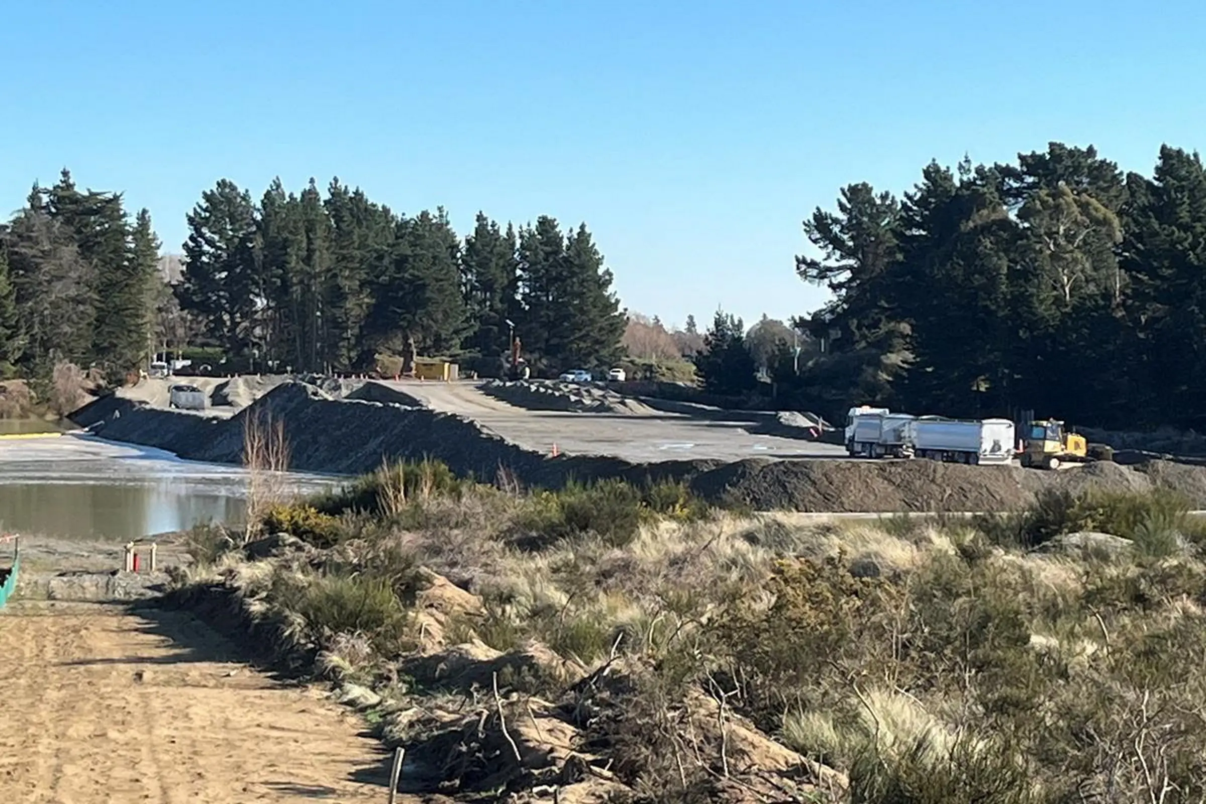 Preparations . . . Road embankment work across two former quarry lakes at Pineacres, near Kaiapoi, to prepare for the Woodend Bypass. Photo: Supplied by Waka Kotahi NZ Transport Agency