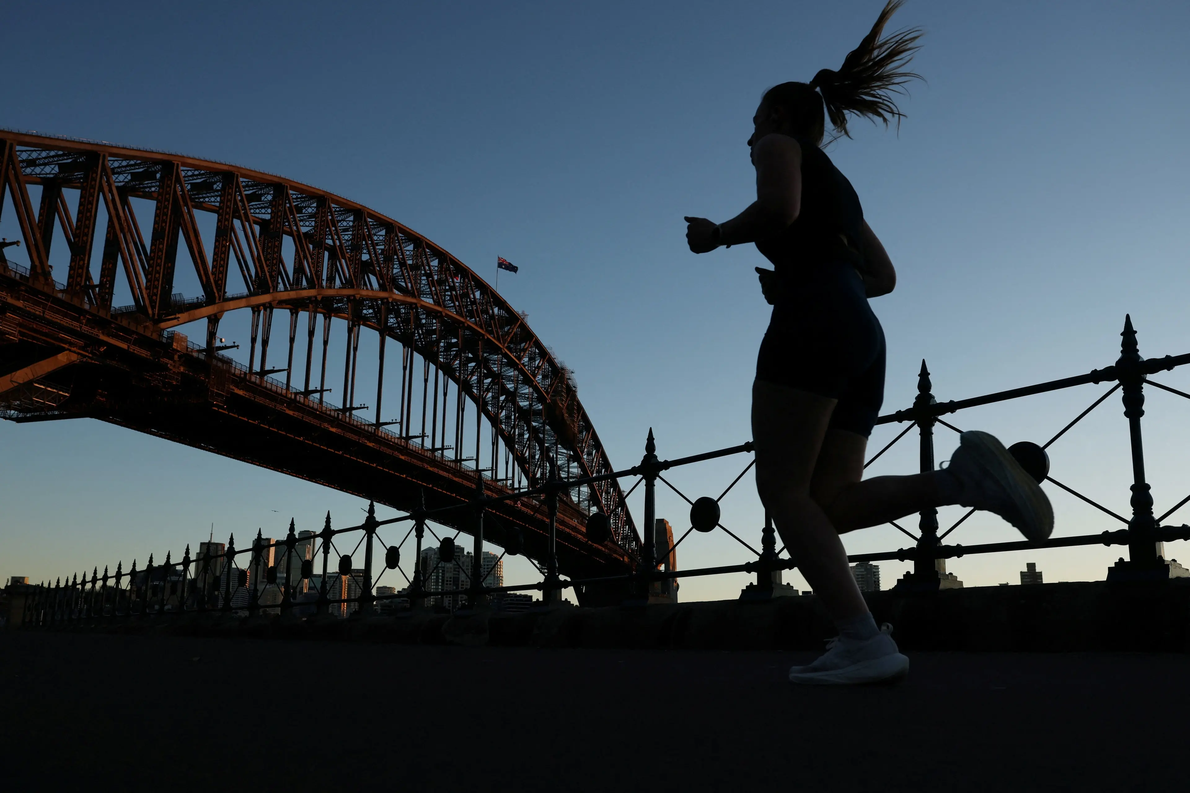 A woman jogs near the Sydney Harbour Bridge. Photo: Reuters/Hollie Adams