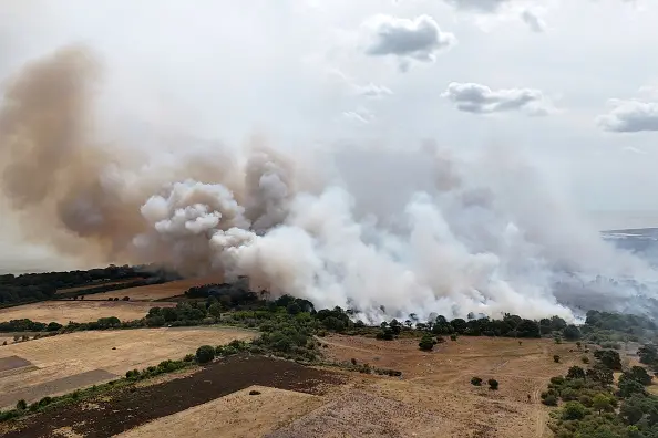 Smoke rises from a wildfire at Dunwich Heath, near Leiston, where a major incident has been declared as firefighters battle a large heathland blaze on the Suffolk coast. Photo: Getty Images