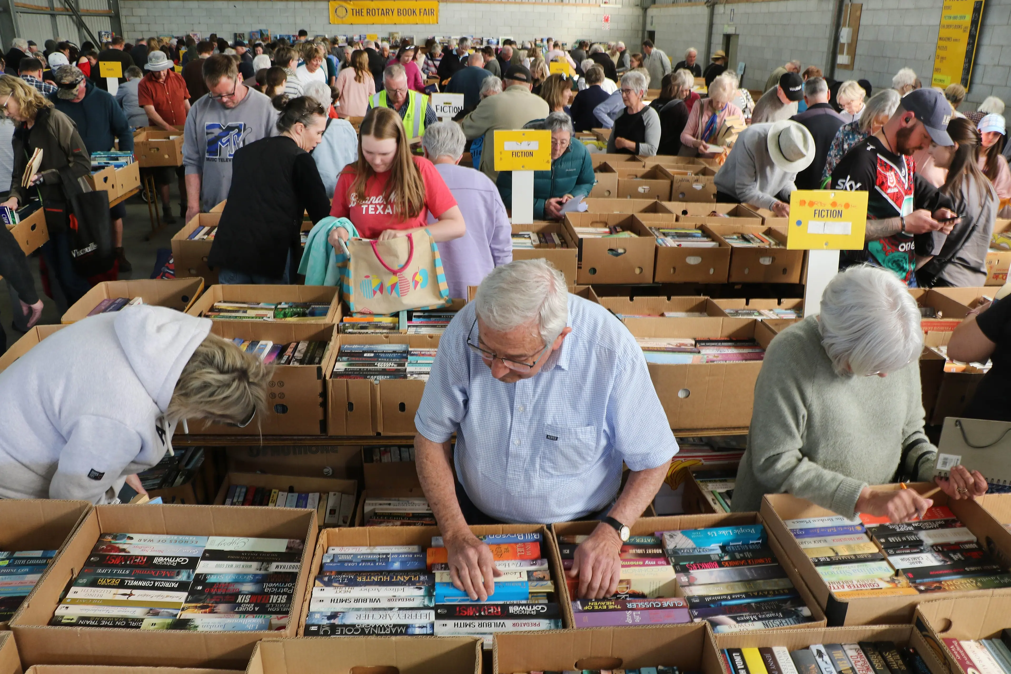Tight fit . . .Hundreds of bargain hunters and book lovers sift through the thousands of books on offer at the annual Rangiora Rotary Book Sale. Photo: John Cosgrove
