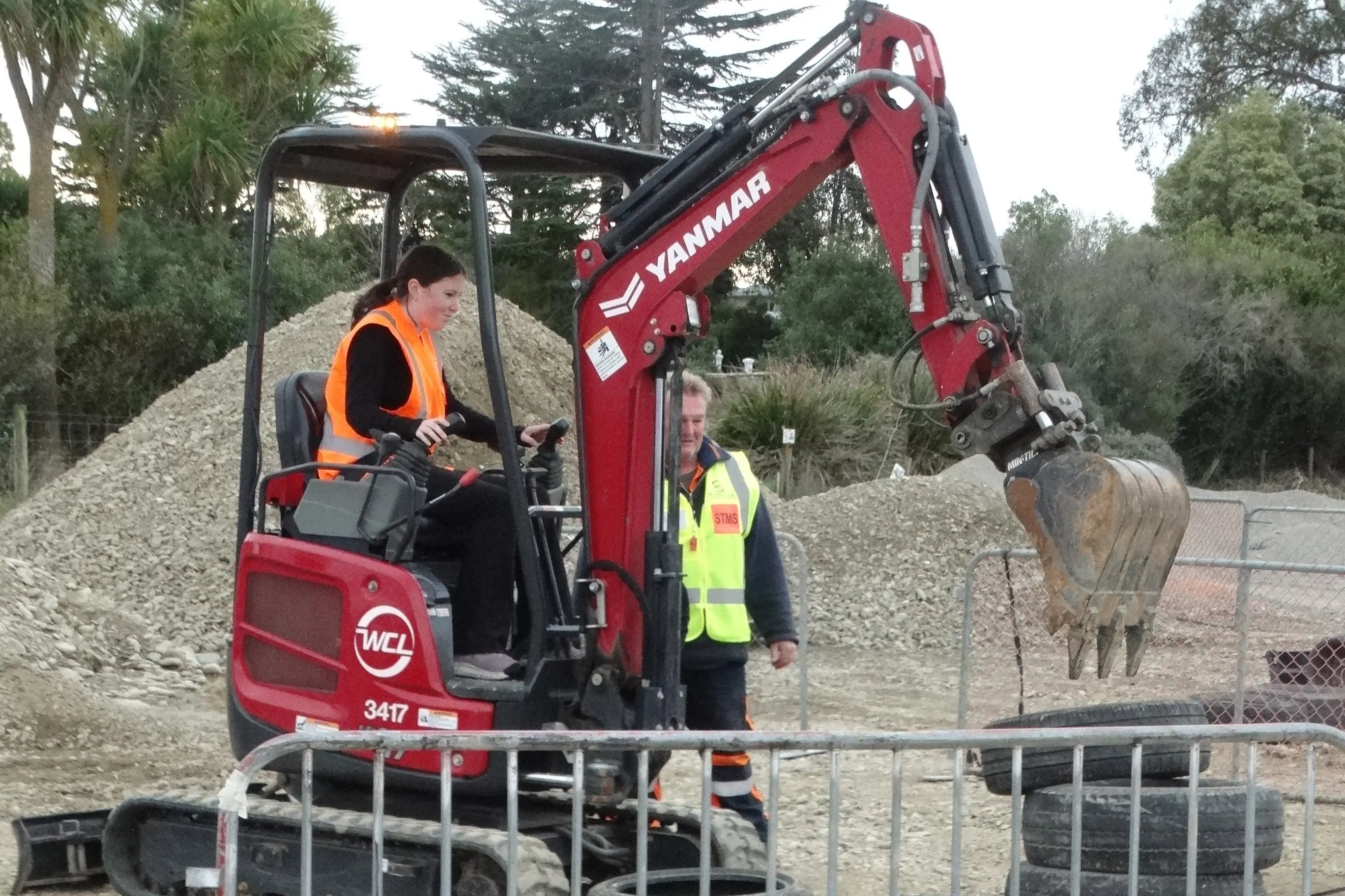 Waitaki Girls\\' High School student Ebony Wallace, 15, has a crack at the tyre stacking challenge while operating an excavator. Photo: Nic Duff