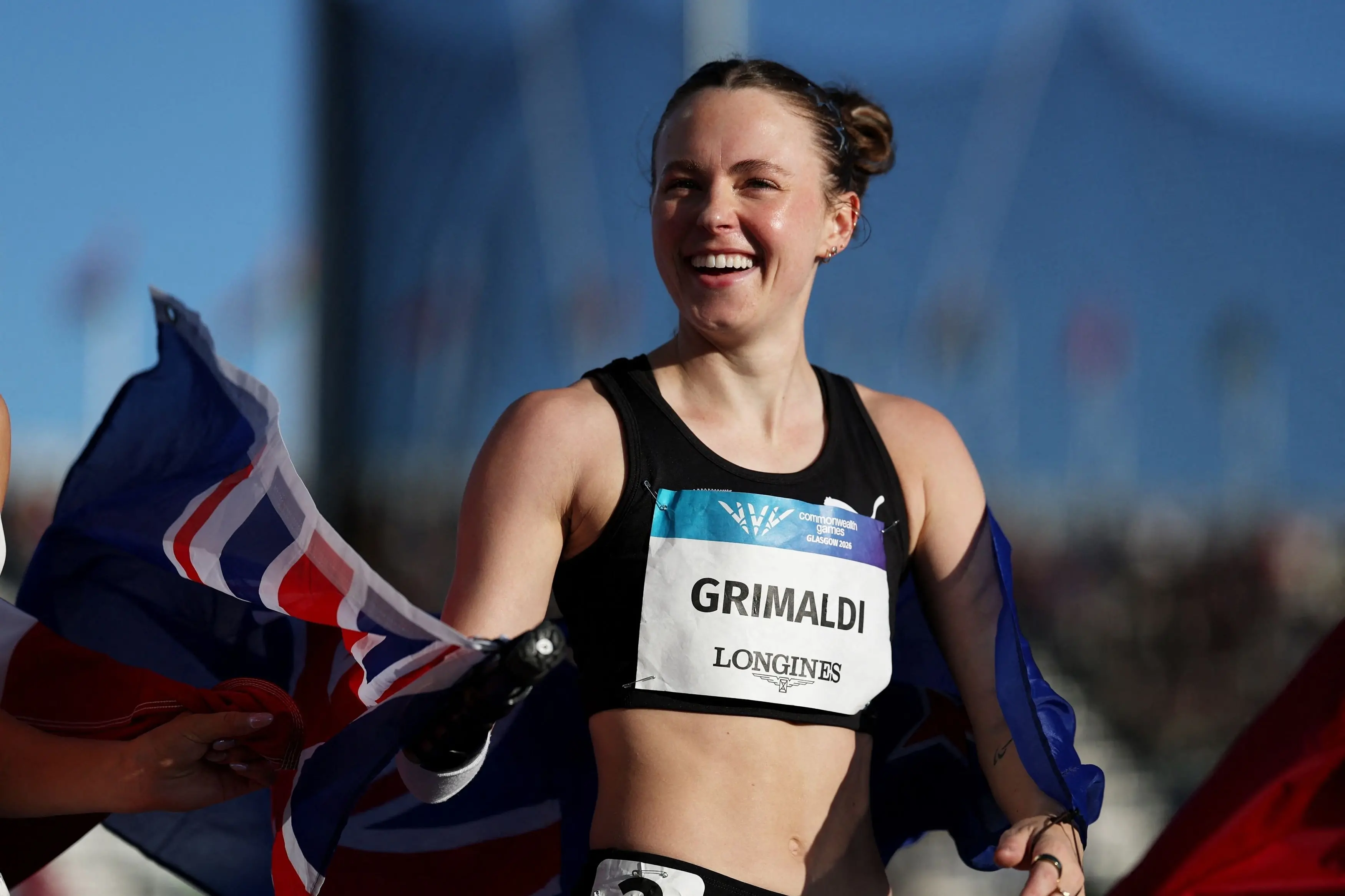 Dunedin\\'s Anna Grimaldi celebrates winning bronze in the women\\'s T47 100m at the Commonwealth Games. Photo: Reuters