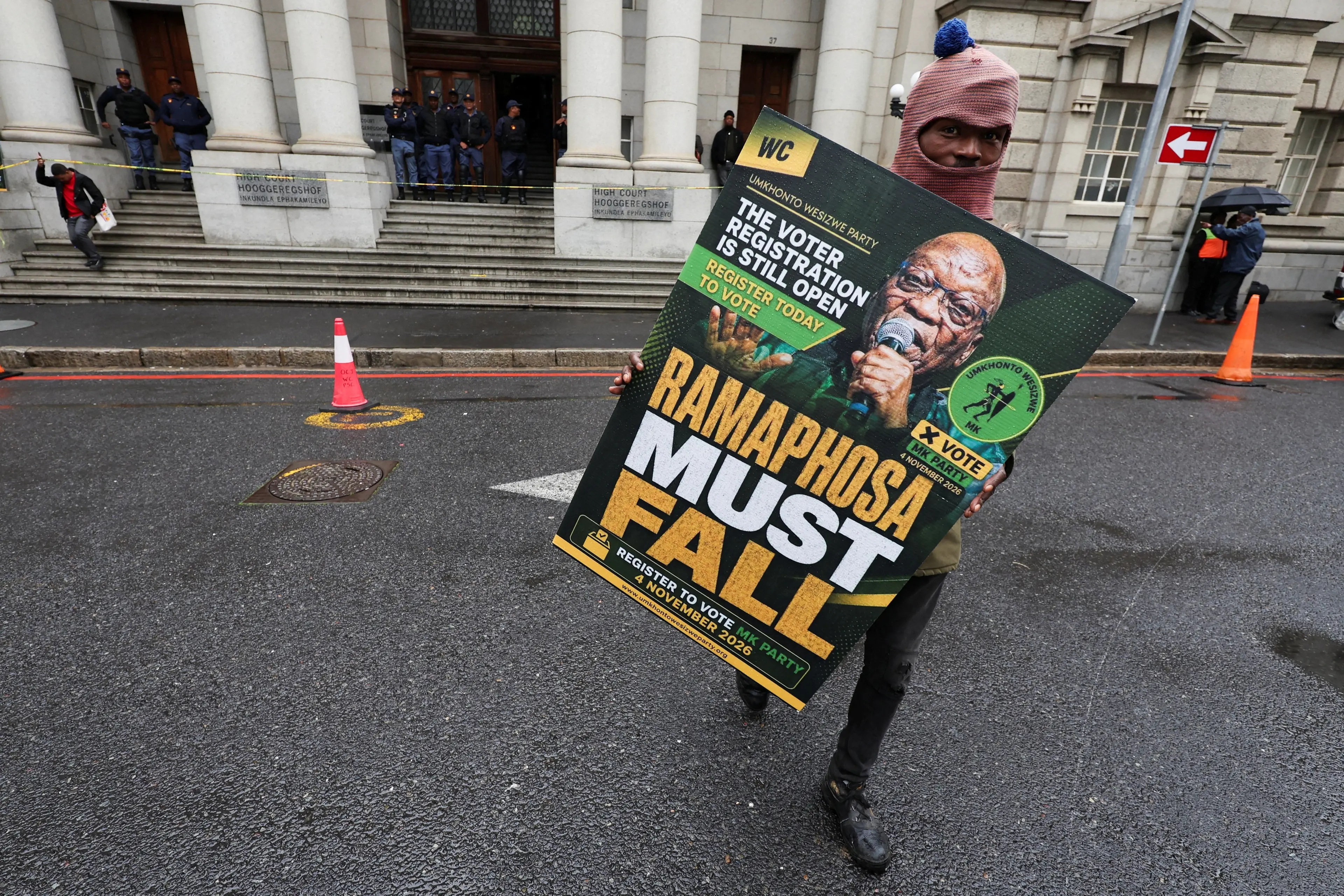A supporter of uMkhonto weSizwe Party outside the Western Cape High Court, where the court was hearing South African President Cyril Ramaphosa\\'s urgent application to temporarily halt impeachment proceedings against him. Photo: Reuters