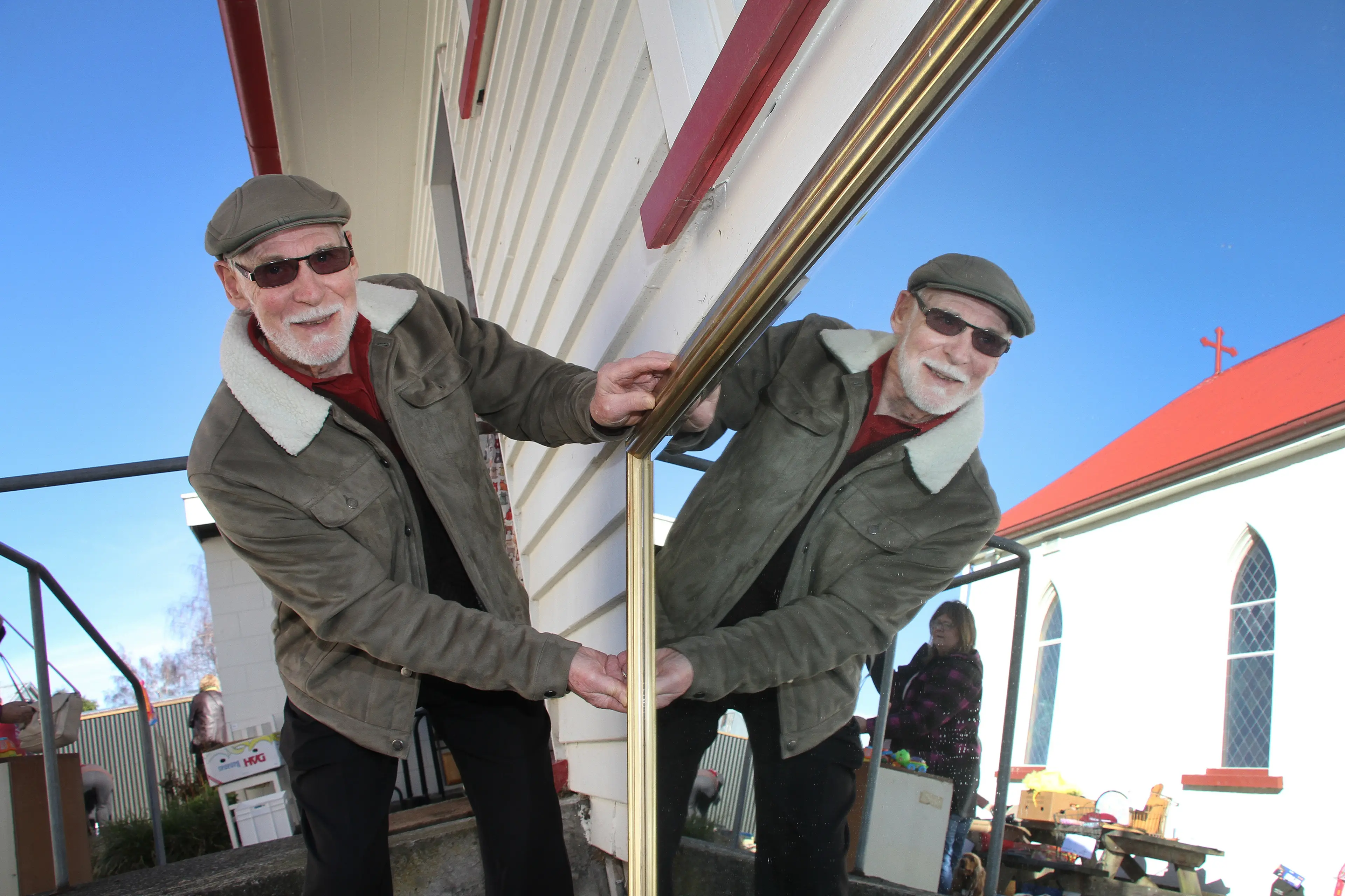 Looking into the future . . . Keith Harris of Oxford, positions a large mirror donated by a parishioner for sale the Catholic Church in Oxford\\u2019s stall at the Great Oxford Garage Sale Trail. Photo: John Cosgrove
