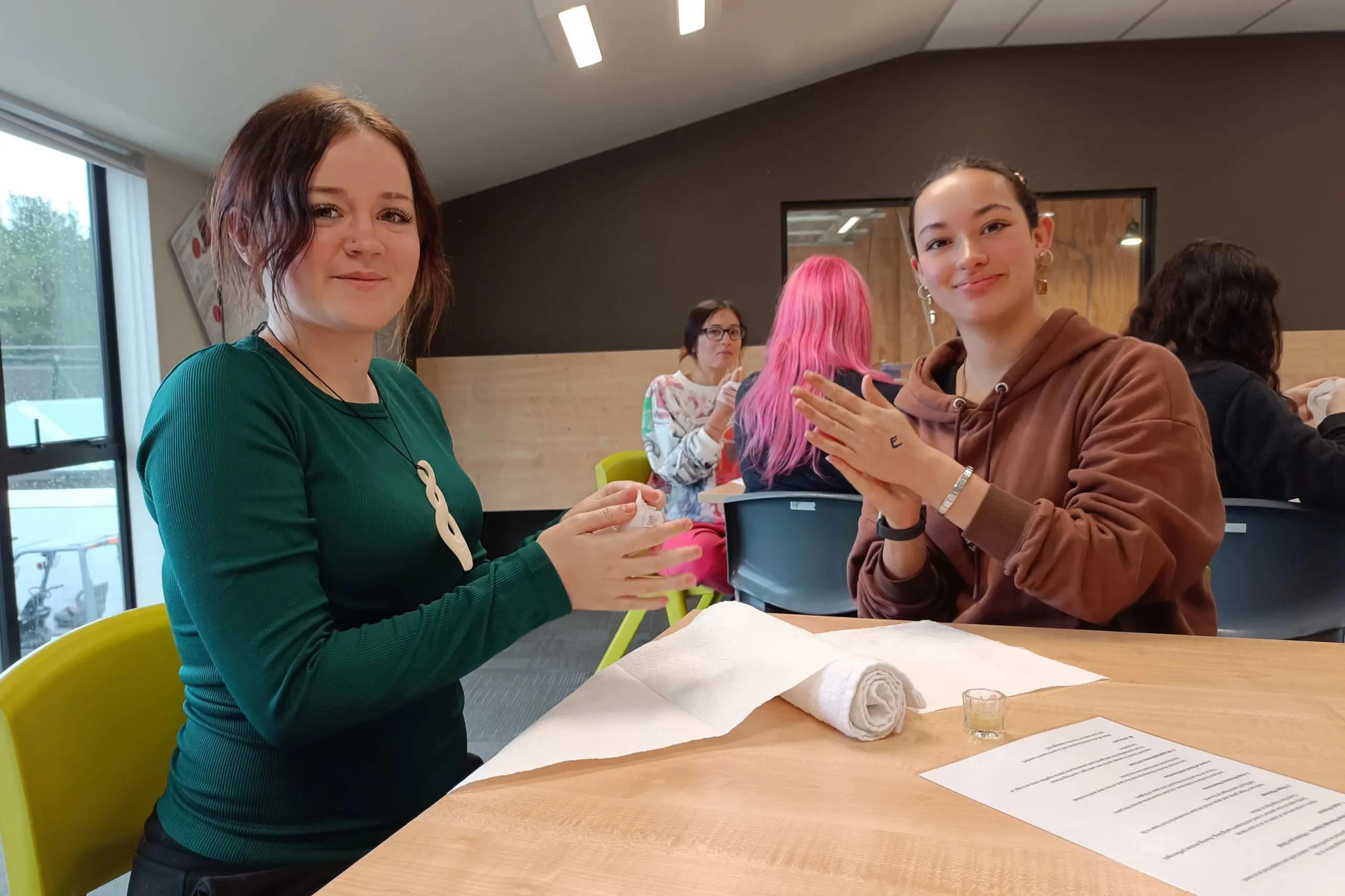 Students Mikyla,15 (left), and Aria, 15, practice their hand massage techniques during a Beauty Therapy session at the Camp Inspire open day. Photo: Supplied
