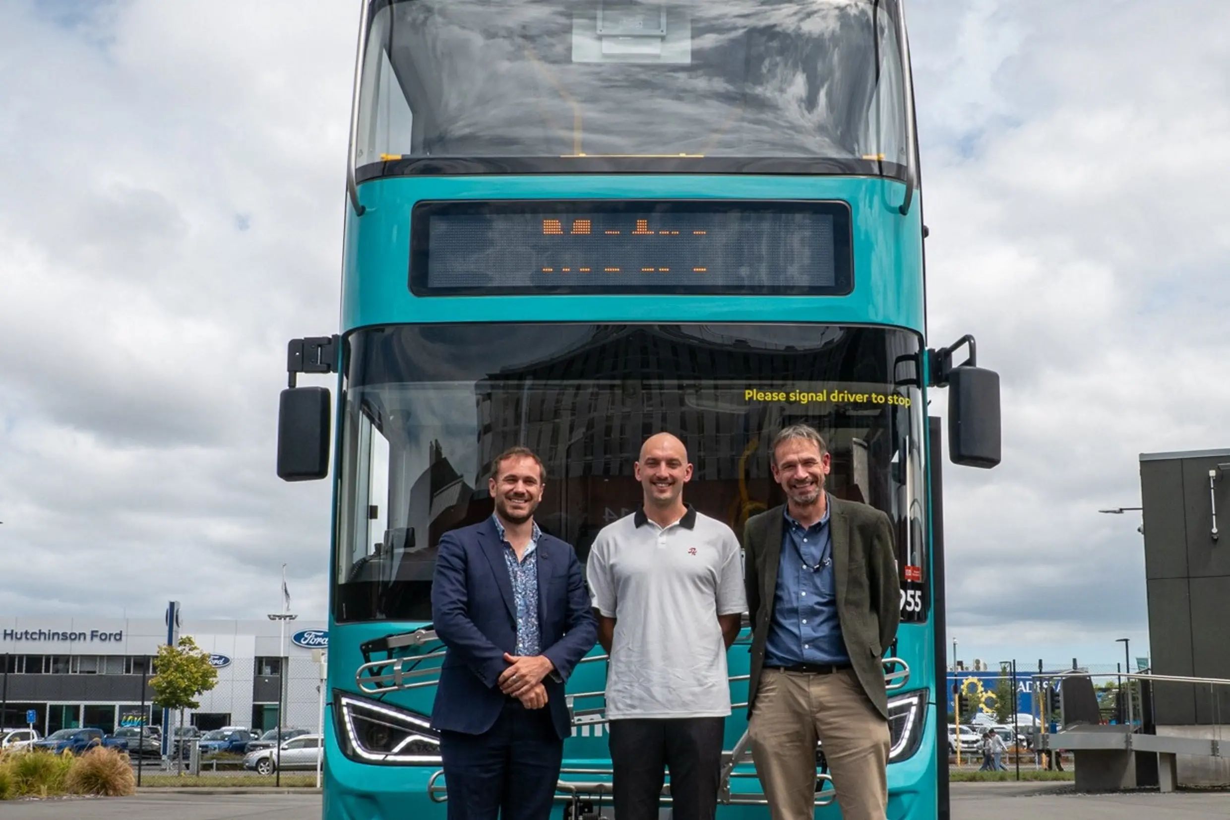 Dr Deon Swiggs (left), ECan councillor Joe Davies and public transport director Giles Southwell in front of a new electric double-decker bus. Public transport is one of several measures the regional council can use to help reduce emissions. Photo: Supplied by Environment Canterbury